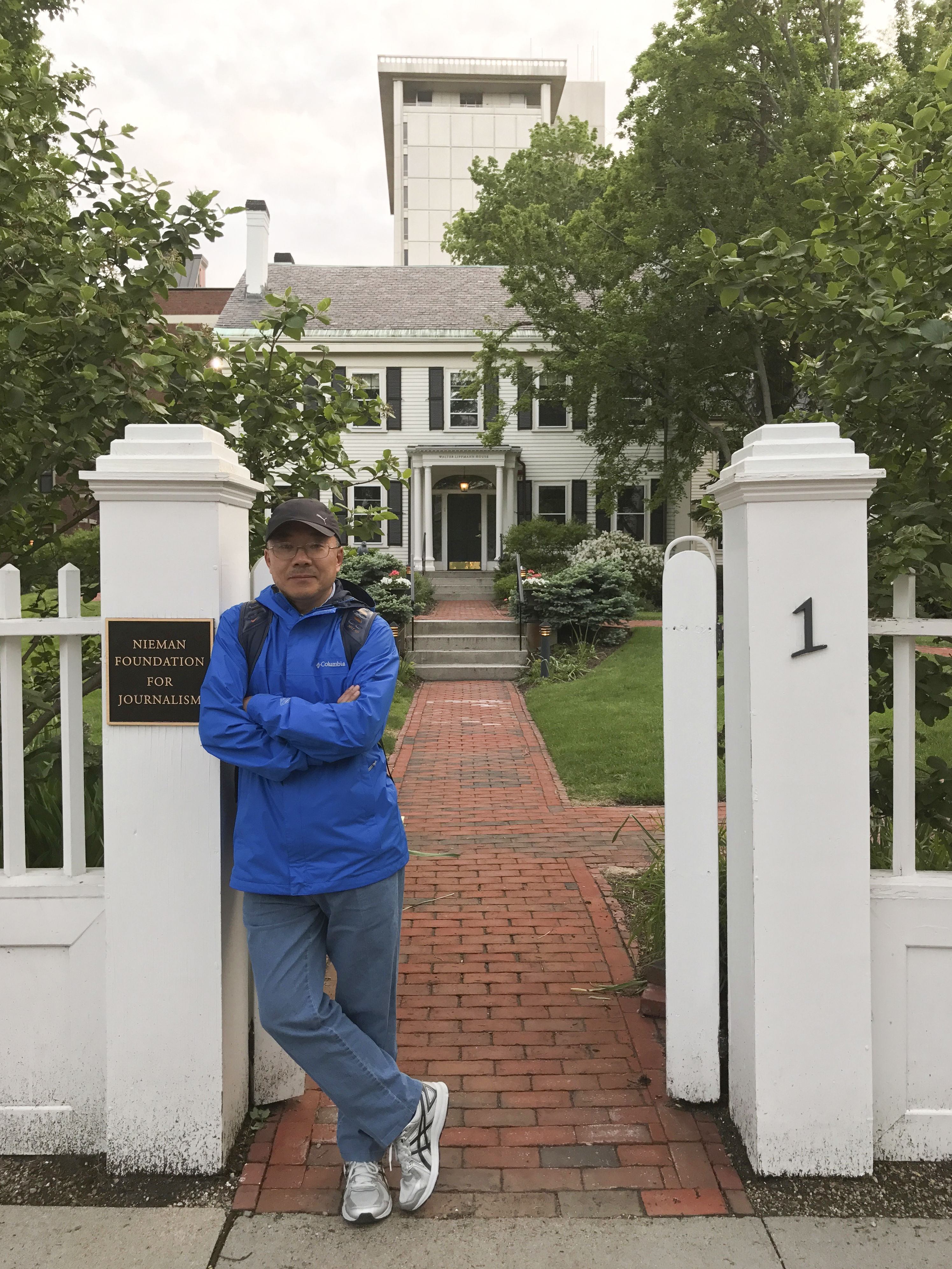 In this photo provided by the Dong family, Chinese journalist Dong Yuyu stands at the gates of the Nieman Foundation for Journalism at Harvard University in Cambridge, Mass., in May 2017. (Courtesy Dong Family via AP)