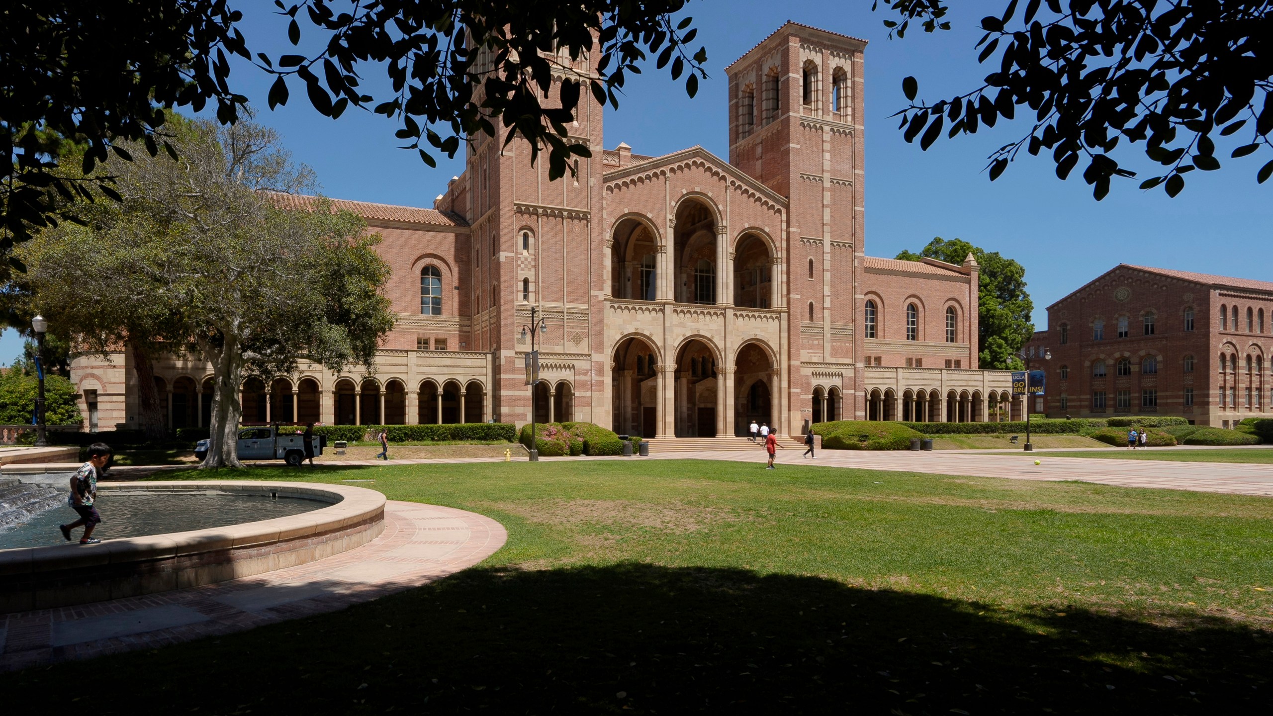 FILE - Children play outside Royce Hall at the University of California, Los Angeles, campus in Los Angeles, Aug. 15, 2024. (AP Photo/Damian Dovarganes, File)