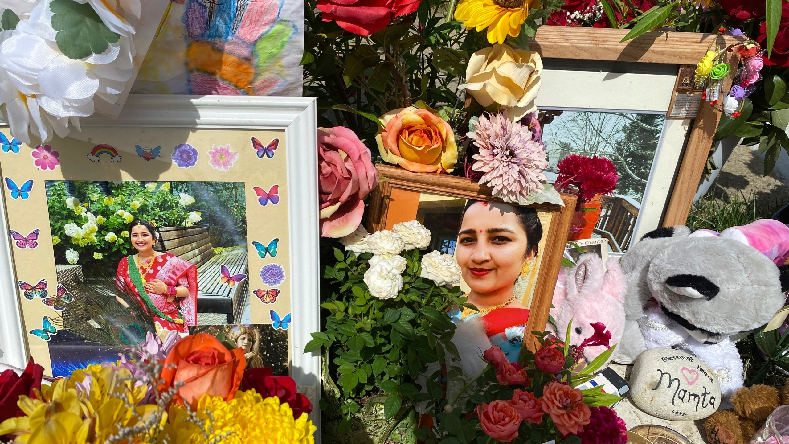 FILE - Flowers, candles and photos are placed near Mamta Kafle Bhatt's mailbox in Manassas Park, Va., Sept. 4, 2024. (AP Photo/Olivia Diaz, File)