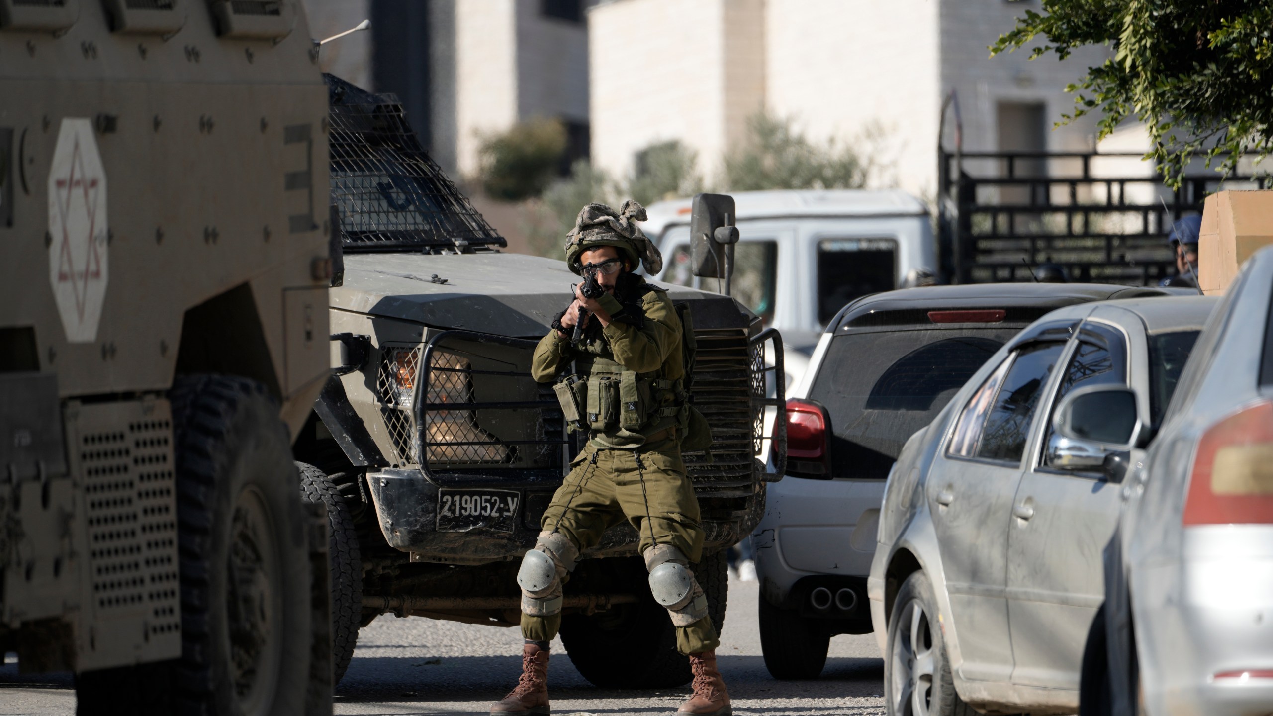 Israeli troops enter the complex of the Turkish hospital, where they searched for the bodies of those killed in an airstrike, in the West Bank city of Tubas, Tuesday Dec. 3, 2024. (AP Photo/Majdi Muhammad)