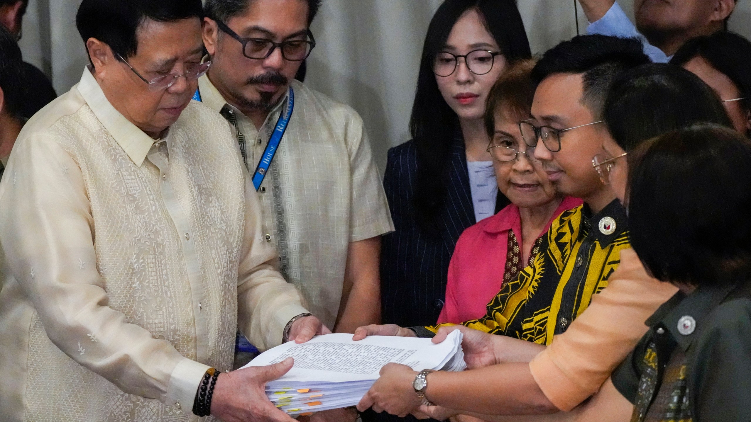 House Secretary General, Reginald Velasco, left, receives a second impeachment complaint filed against Philippine Vice President Sara Duterte on Wednesday Dec. 4, 2024 at the House of Representatives in Quezon City, Philippines. (AP Photo/Aaron Favila)