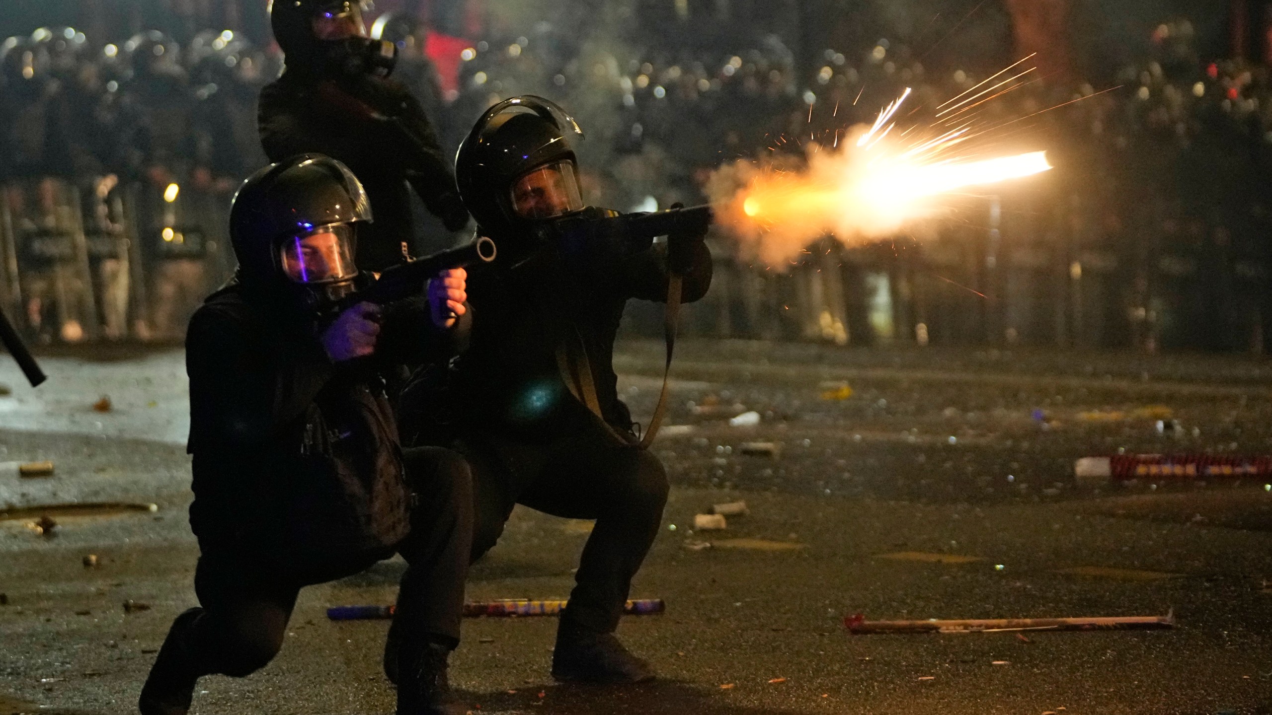 Police shoot tear gas towards demonstrators during a protest against the government's decision to suspend negotiations on joining the European Union in Tbilisi, Georgia, early Wednesday, Dec. 4, 2024. (AP Photo/Pavel Bednyakov)