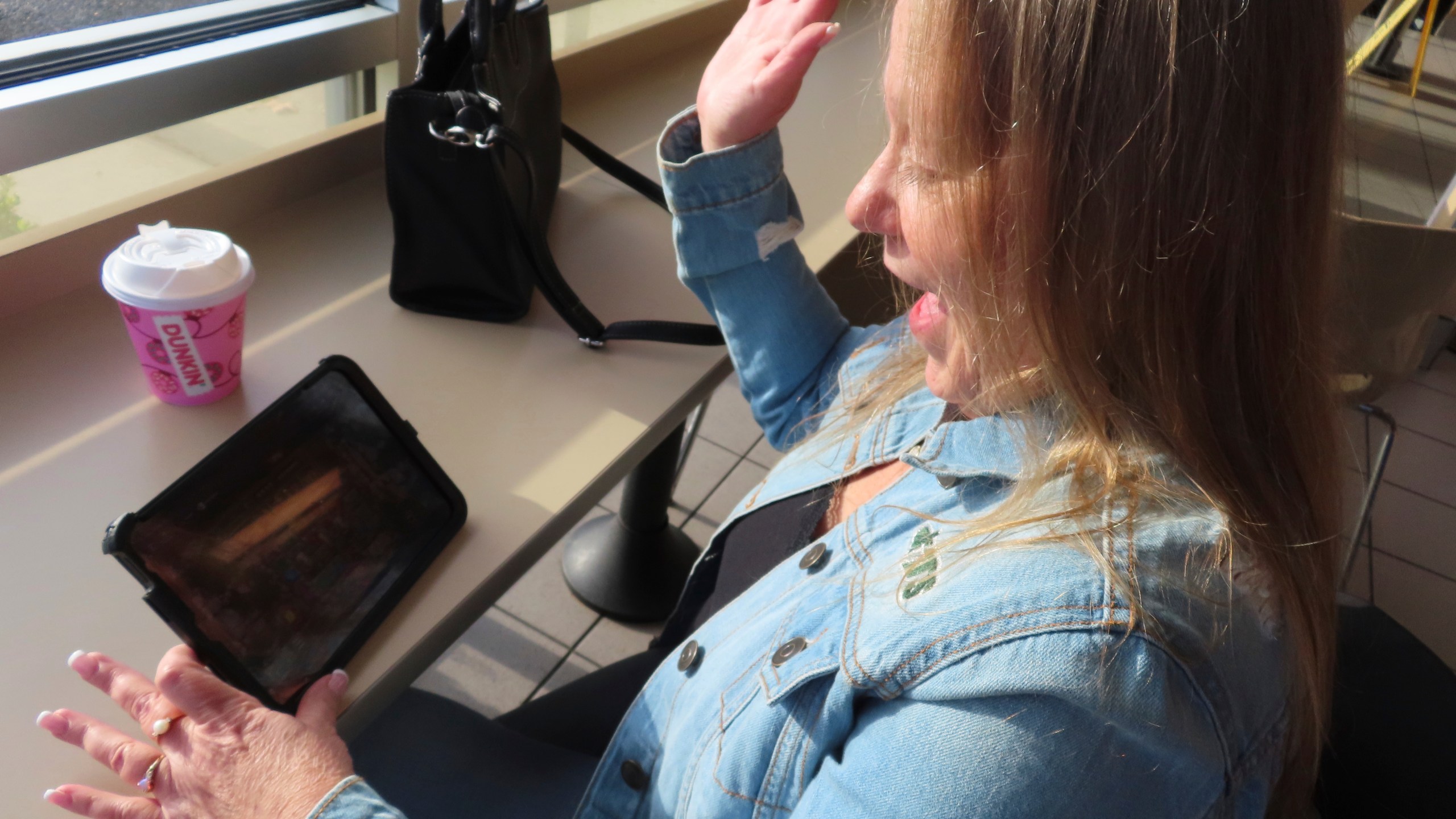 Elaine Vallaster reacts to a winning spin while playing an internet slots game on her tablet in Hazlet, N.J. on Nov. 24, 2023. (AP Photo/Wayne Parry)