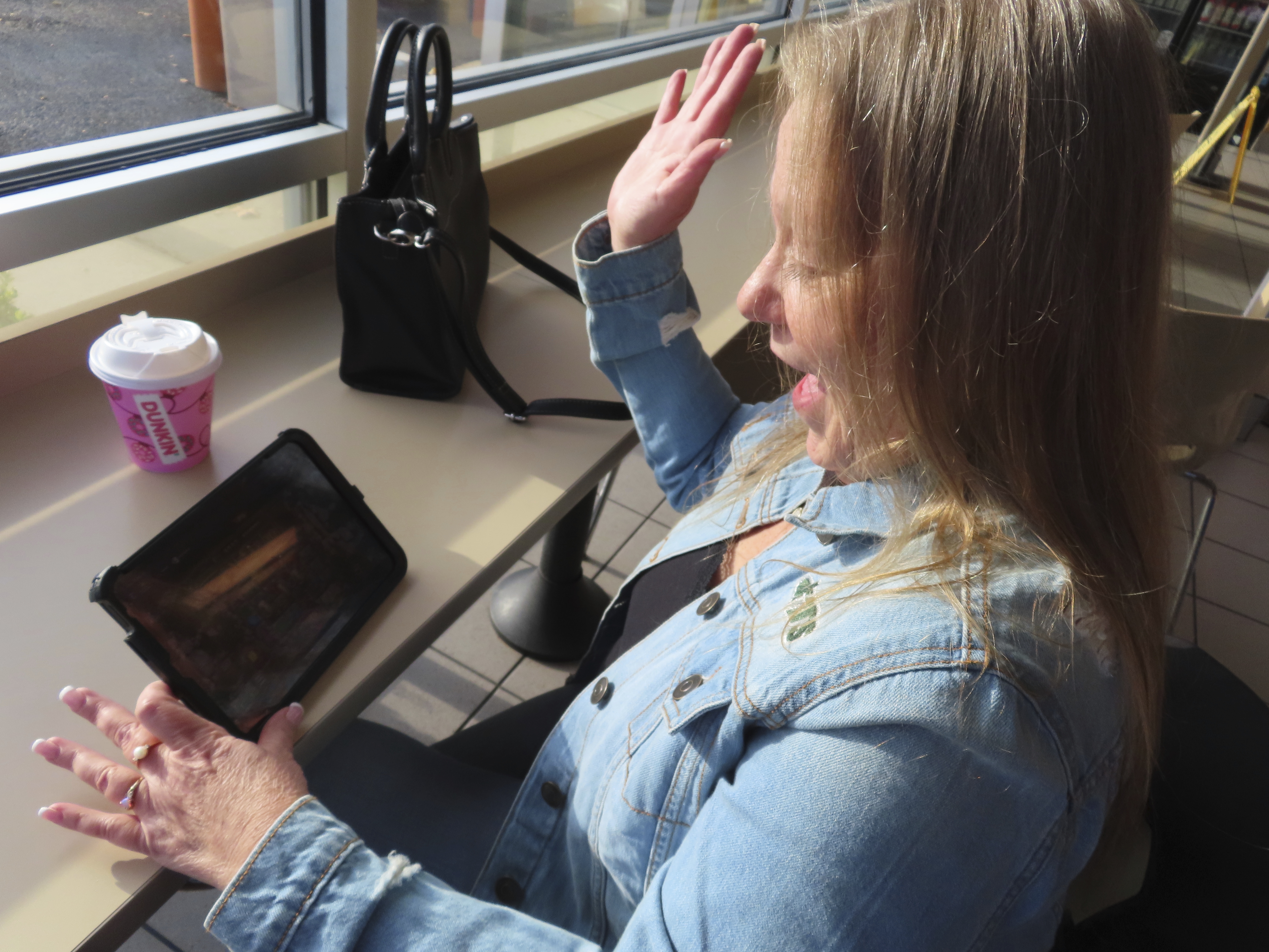 Elaine Vallaster reacts to a winning spin while playing an internet slots game on her tablet in Hazlet, N.J. on Nov. 24, 2023. (AP Photo/Wayne Parry)