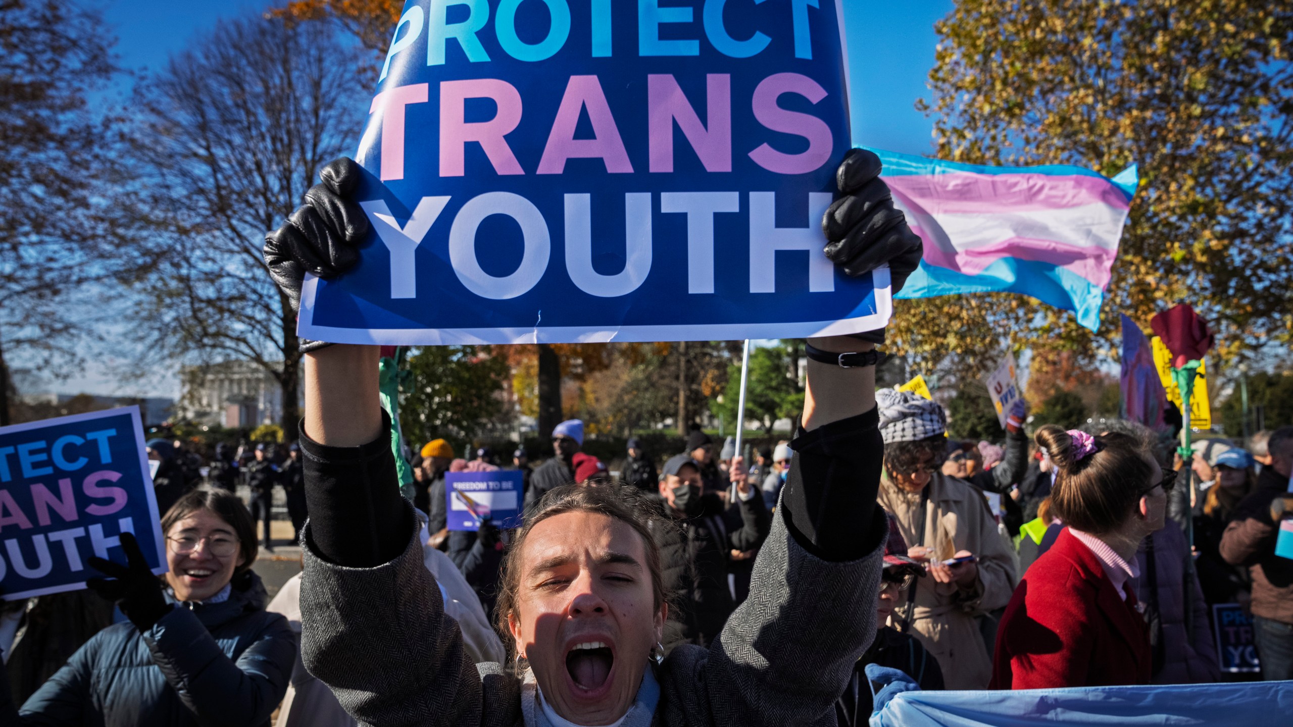 A young person who preferred not to give her name, cheers as supporters of transgender rights rally by the Supreme Court, Wednesday, Dec. 4, 2024, in Washington, while arguments are underway in a case regarding a Tennessee law banning gender-affirming medical care for transgender youth. (AP Photo/Jacquelyn Martin)