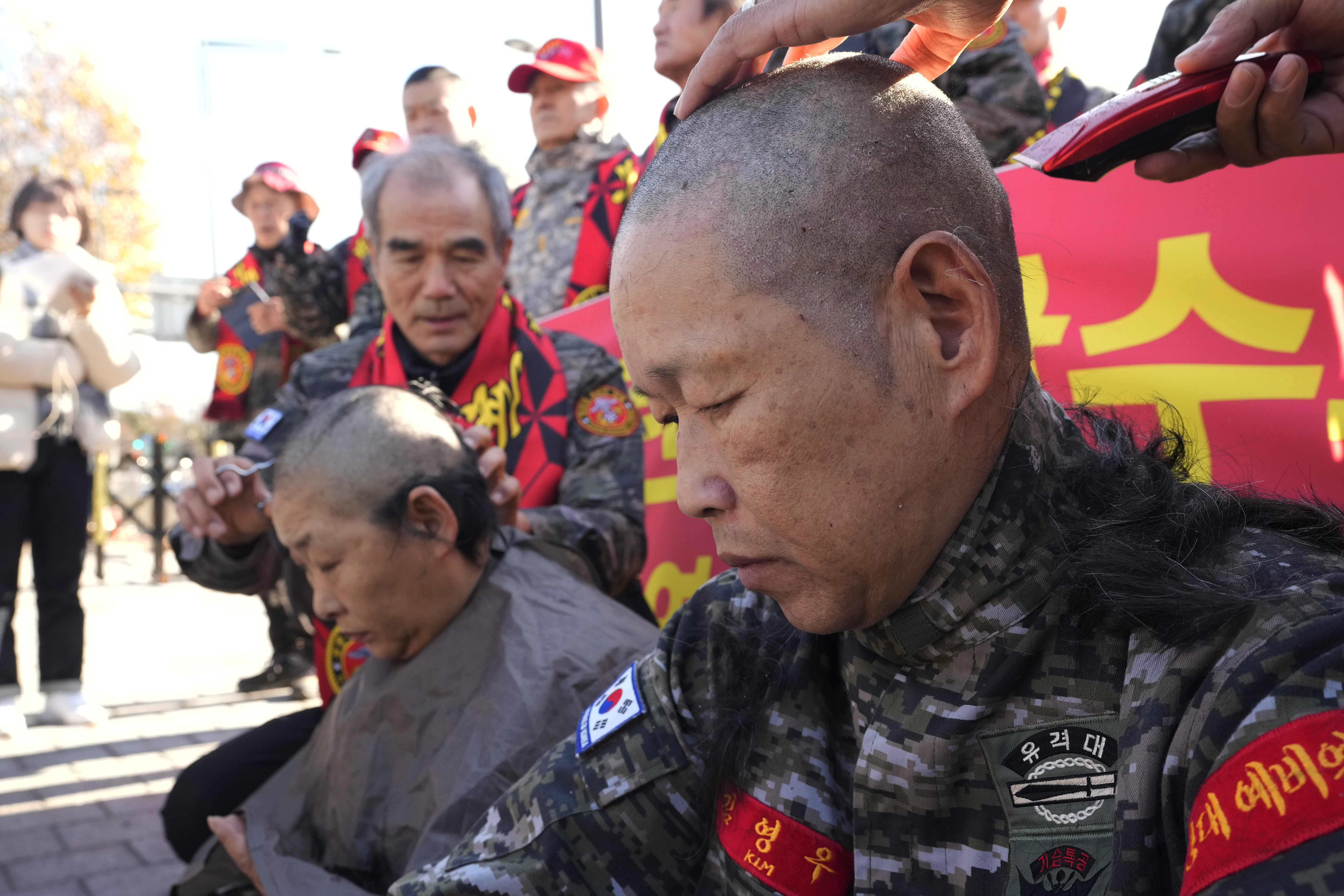 South Korean marine veterans get their heads shaved during a rally against President Yoon Suk Yeol in front of the presidential office in Seoul, South Korea, Thursday, Dec. 5, 2024. (AP Photo/Ahn Young-joon)