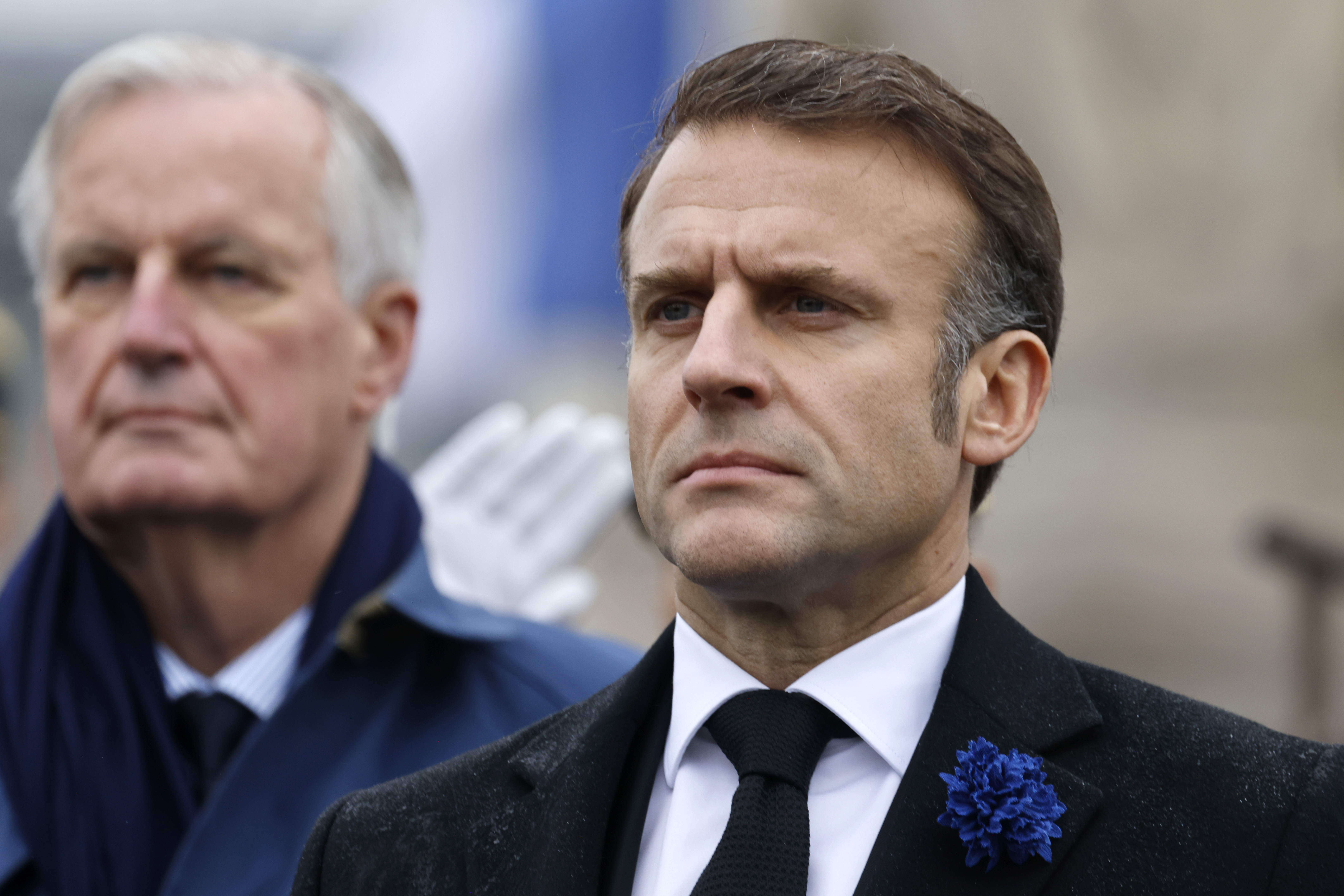 FILE - French President Emmanuel Macron, right, and Prime Minister Michel Barnier stand at attention during commemorations marking the 106th anniversary of the November 11, 1918, Armistice, ending World War I, at the Arc de Triomphe in Paris, Monday, Nov. 11, 2024. ( Ludovic Marin, Pool via AP, File)