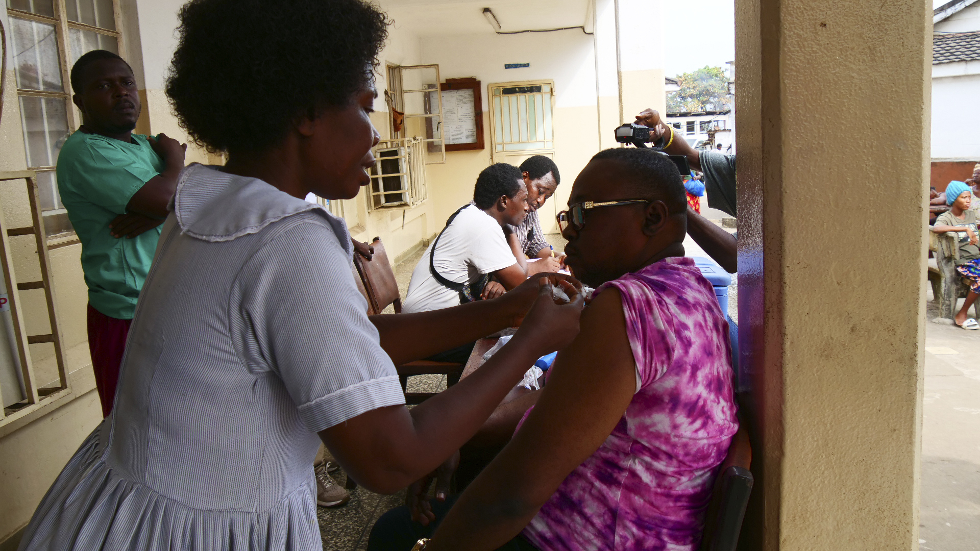 A health worker administers a single-dose of Ebola vaccine, to a man at the Christian Maternity Hospital in Freetown, Sierra Leone, Thursday, Dec. 5, 2024. (AP Photo/Dennis Alfred Cole)