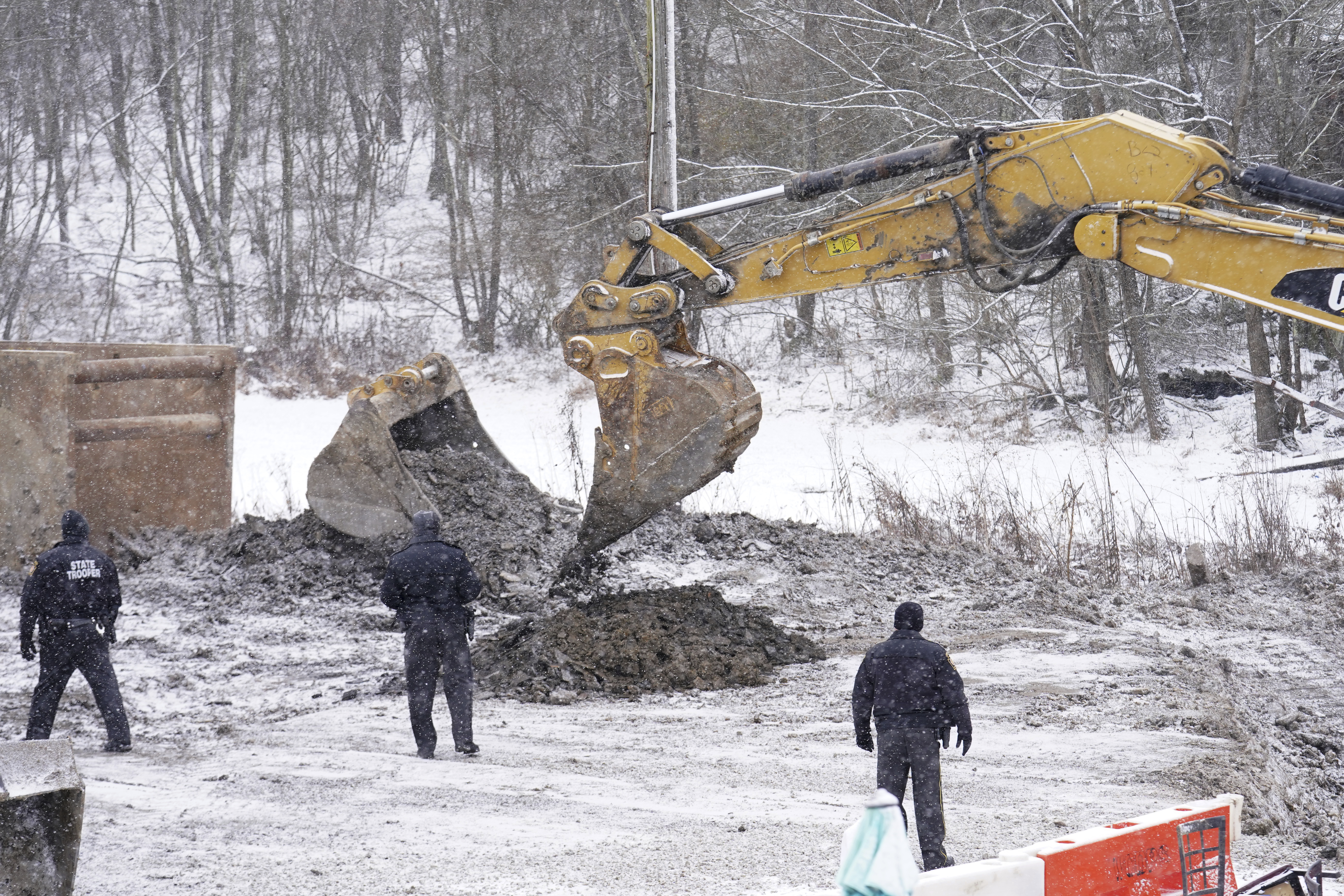 Rescue workers continue to search, Thursday, Dec. 5, 2024, for Elizabeth Pollard, who is believed to have disappeared in a sinkhole while looking for her cat, in Marguerite, Pa. (AP Photo/Matt Freed)