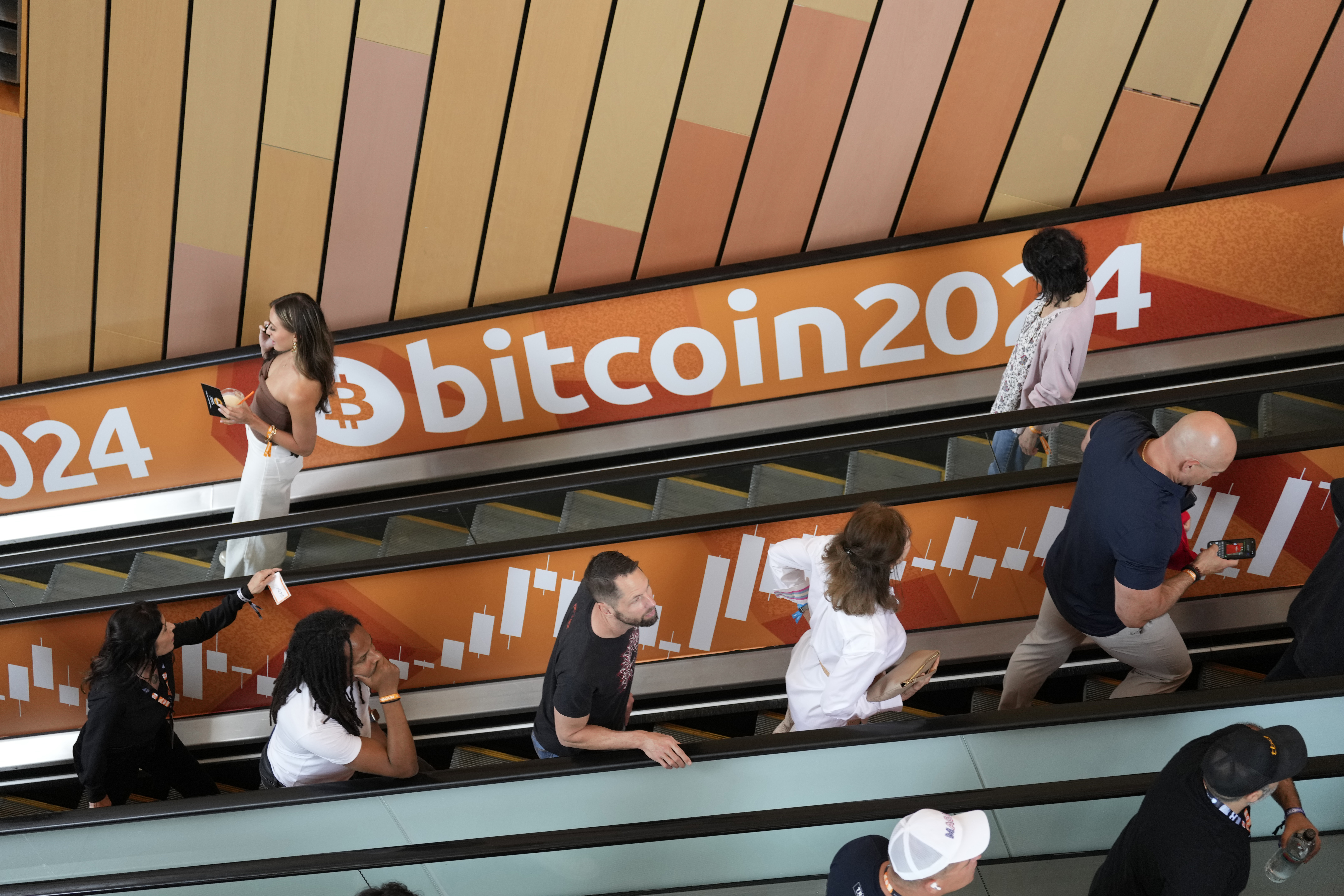 FILE - People arrive at the Bitcoin 2024 Conference on July 24, 2024, in Nashville, Tenn. (AP Photo/Mark Humphrey, File)