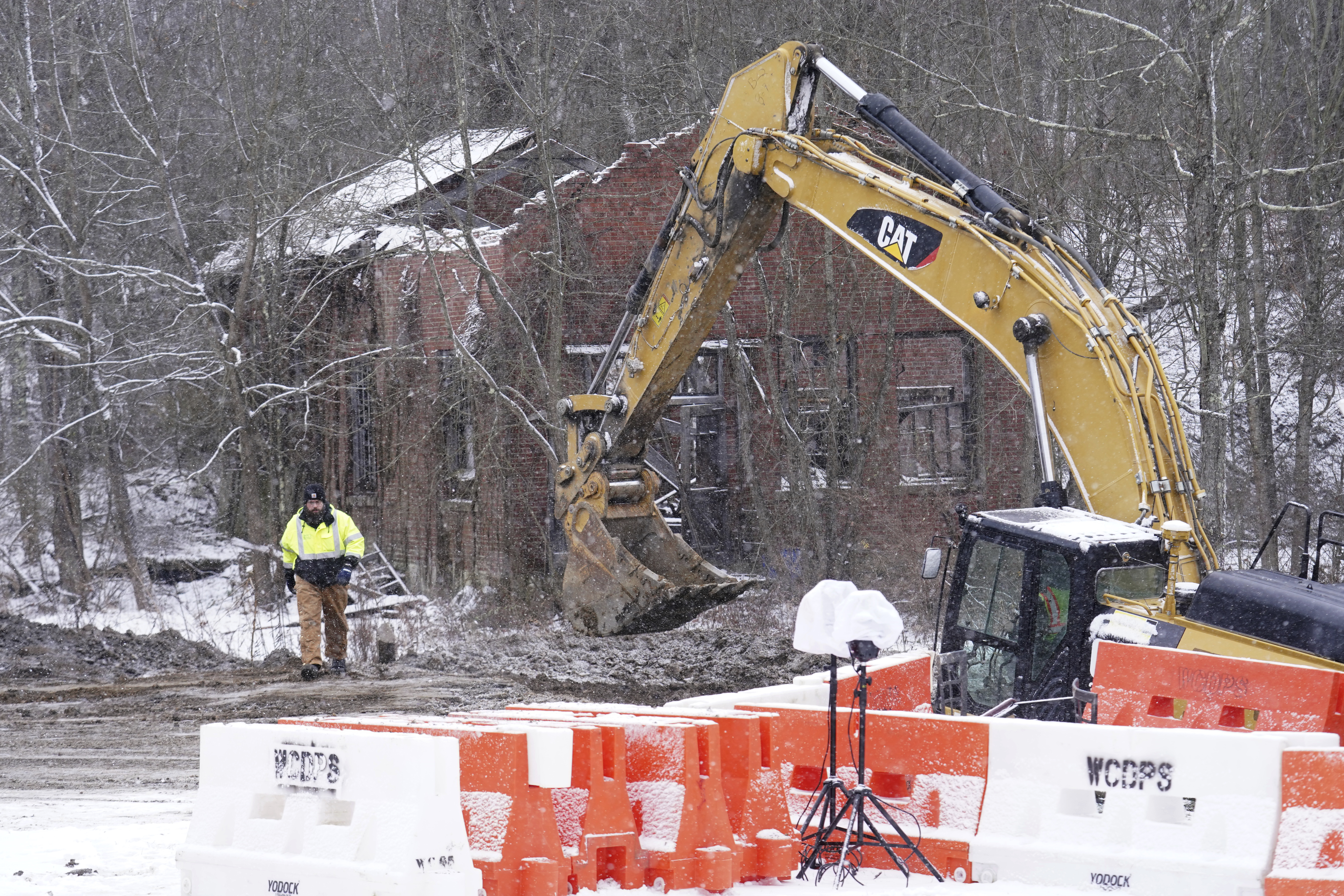 Rescue workers continue to search, Thursday, Dec. 5, 2024, for Elizabeth Pollard, who is believed to have disappeared in a sinkhole while looking for her cat, in Marguerite, Pa. (AP Photo/Matt Freed)