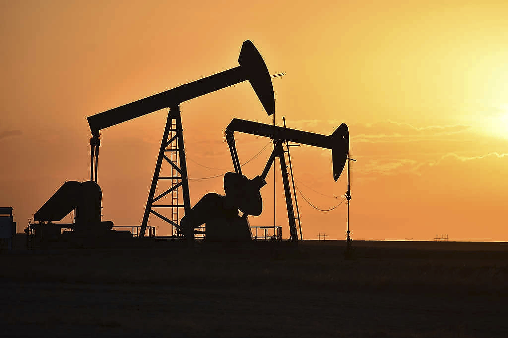 FILE - Pump jacks extract oil from beneath the ground in North Dakota, May 19, 2021. (AP Photo/Matthew Brown, File)