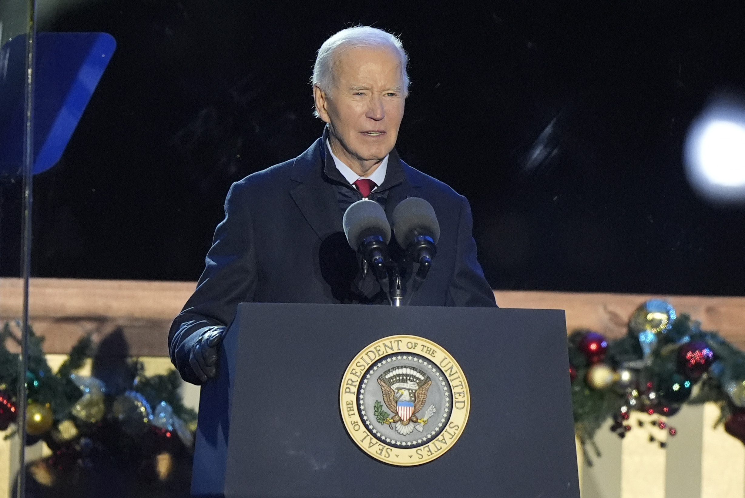 President Joe Biden speaks during a ceremony to light the National Christmas Tree on the Ellipse near the White House in Washington, Thursday, Dec. 5, 2024. (AP Photo/Mark Schiefelbein)