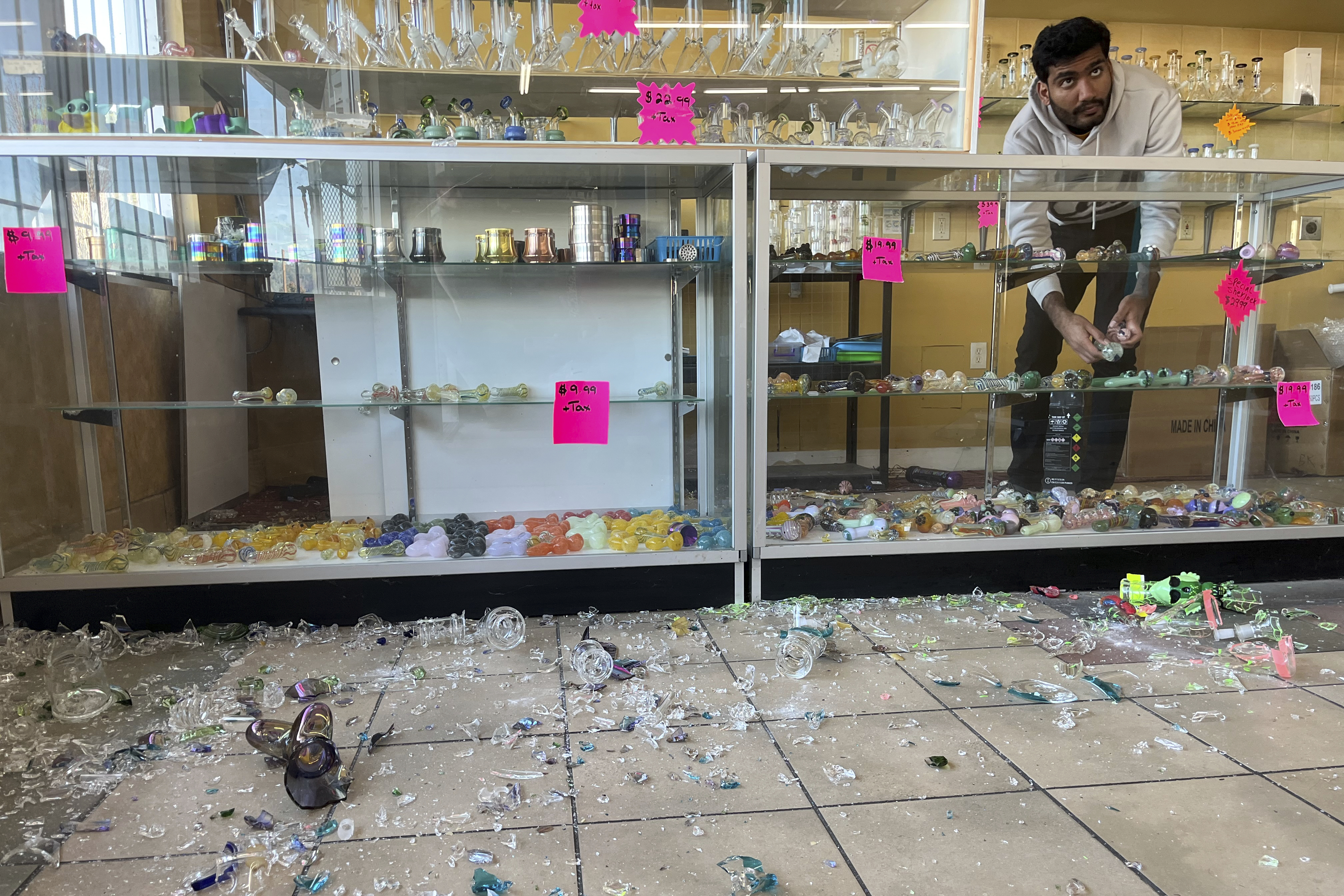 Hasan Raza cleans up in the aftermath of a 7.0 earthquake inside E&J Liquors, Thursday, Dec. 5, 2024, in Rio Dell, Calif. (Savana Robinson via AP)