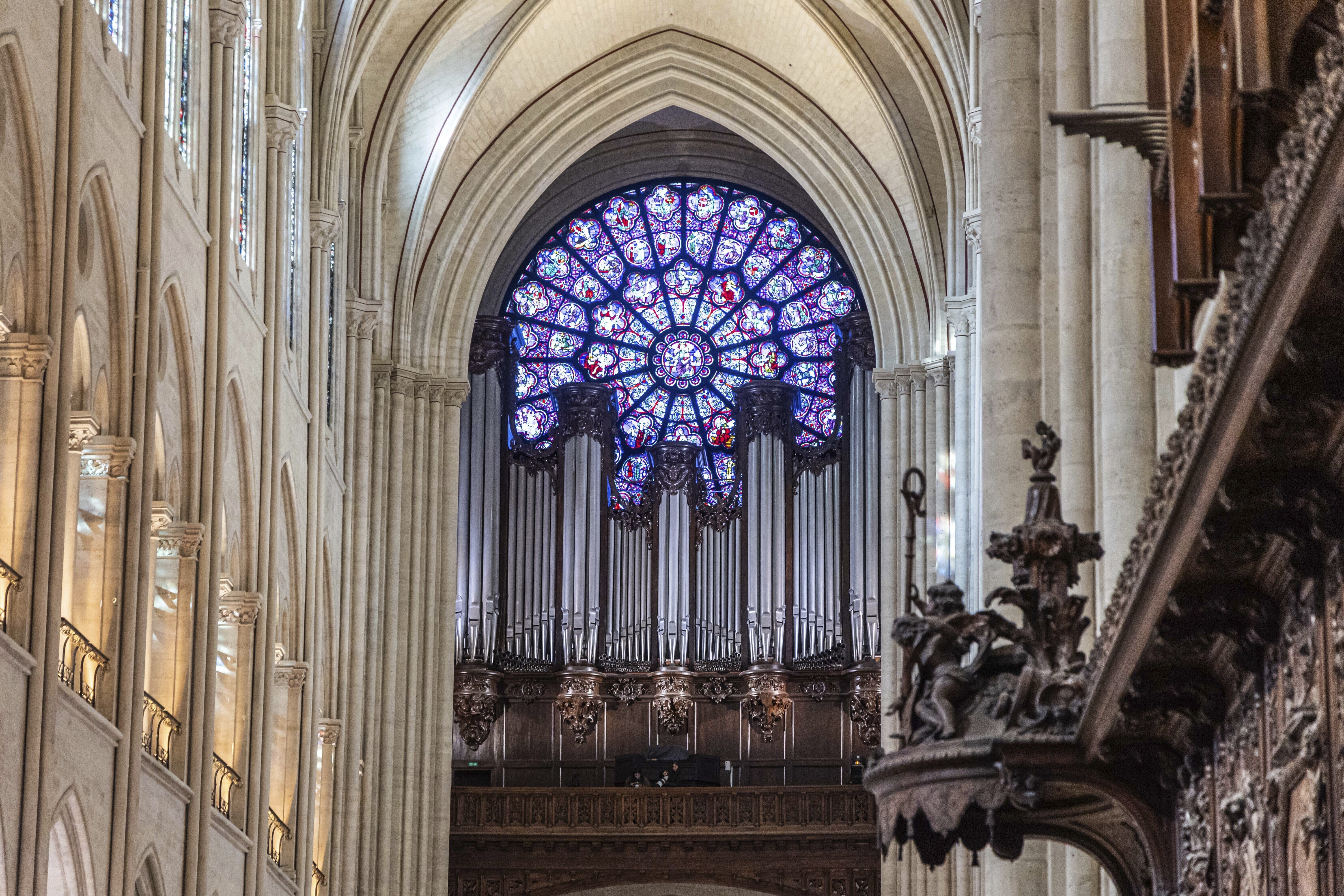 FILE - View of the stained glass rose window and the great organs as French President Emmanuel Macron visits the restored interiors of the Notre-Dame de Paris cathedral, Friday, Nov. 29, 2024 in Paris. (Christophe Petit Tesson/Pool via AP, File)