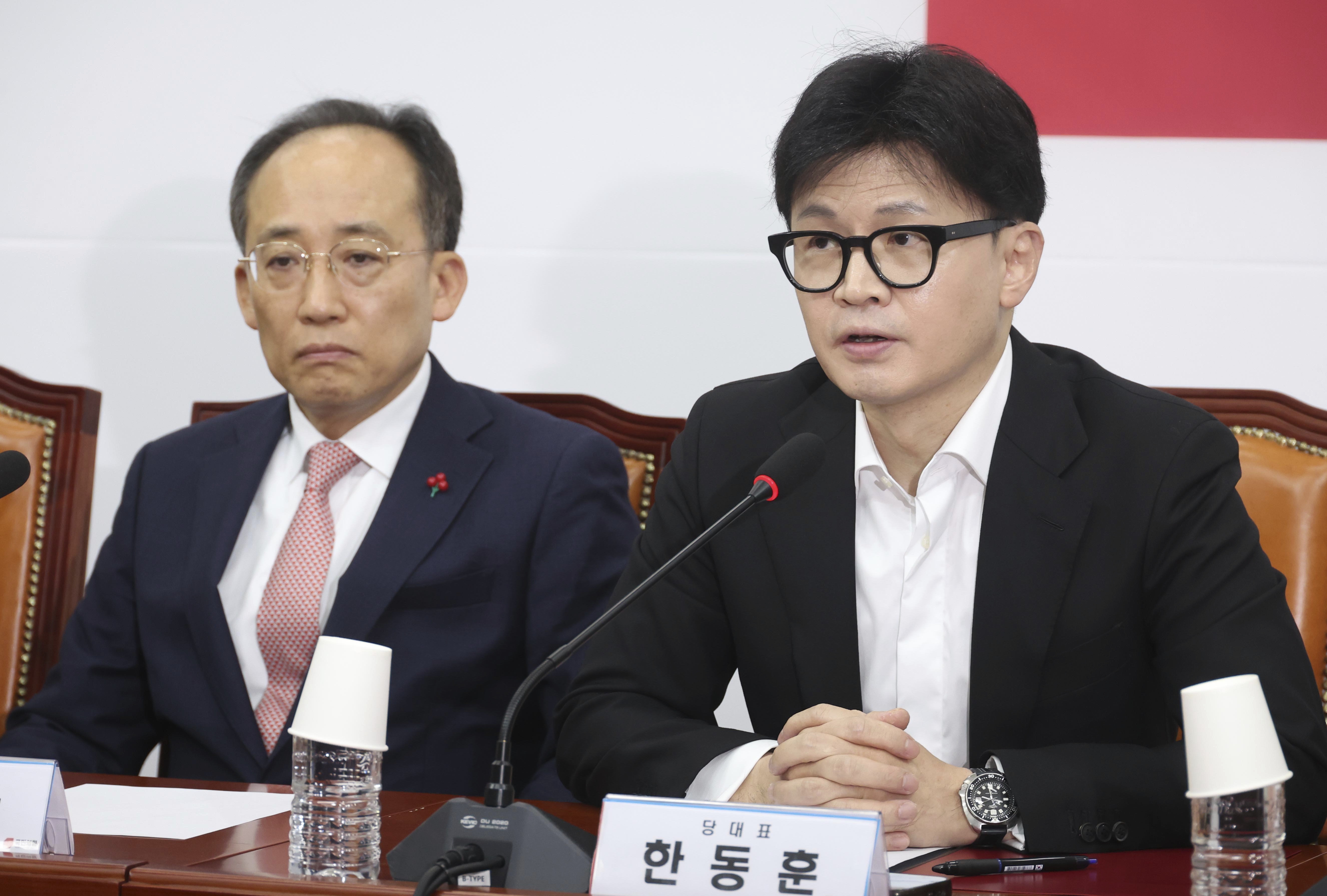 South Korea's ruling People Power Party leader Han Dong-hun, right, speaks during a press conference at the National Assembly in Seoul, South Korea, Friday, Dec. 6, 2024. (Jo Sung-bong/Newsis via AP)