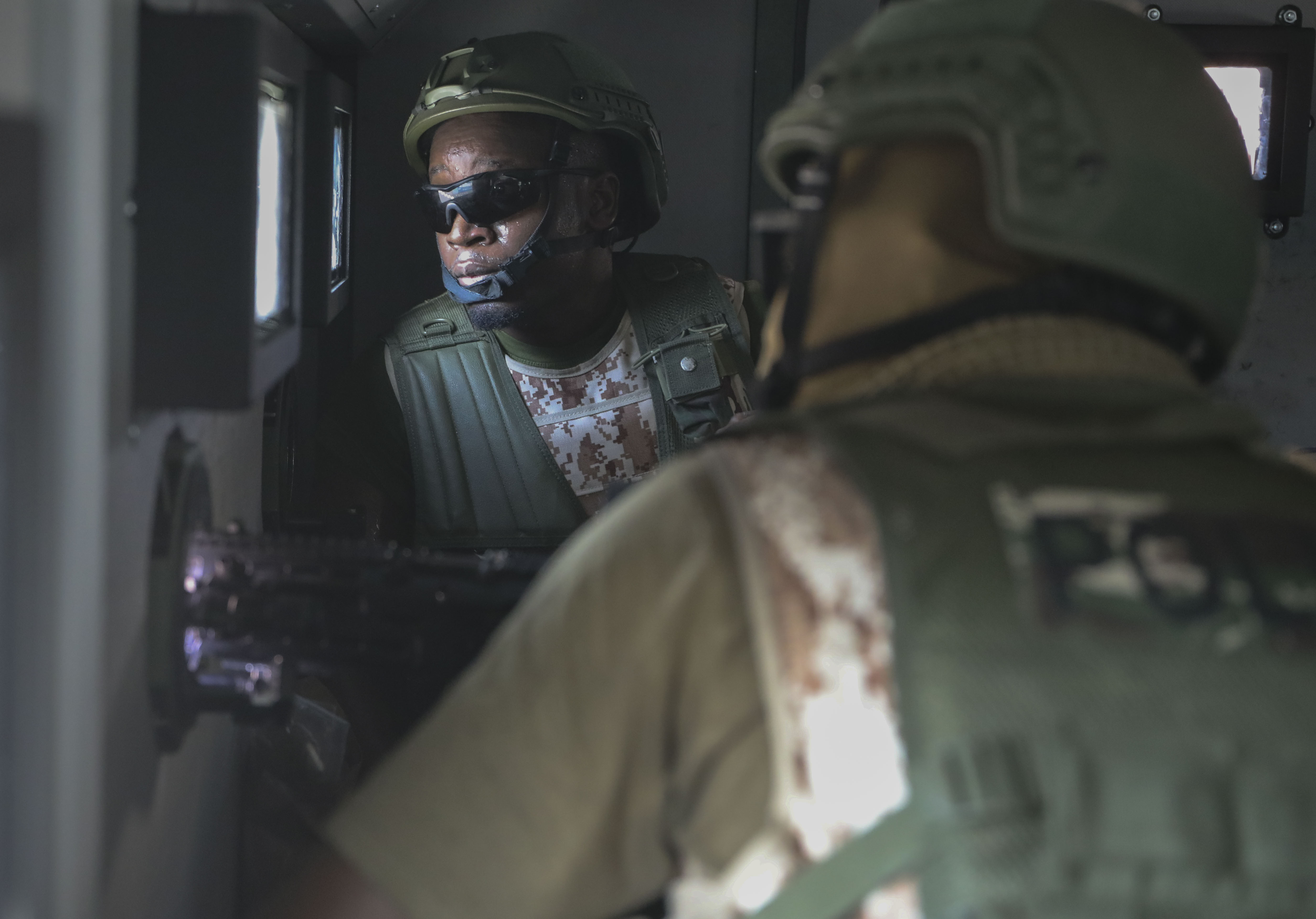 Kenyan police officers, part of a U.N.-backed multinational force, aim weapons out of an armored vehicle in Port-au-Prince, Haiti, Thursday, Dec. 5, 2024. (AP Photo/Odelyn Joseph)