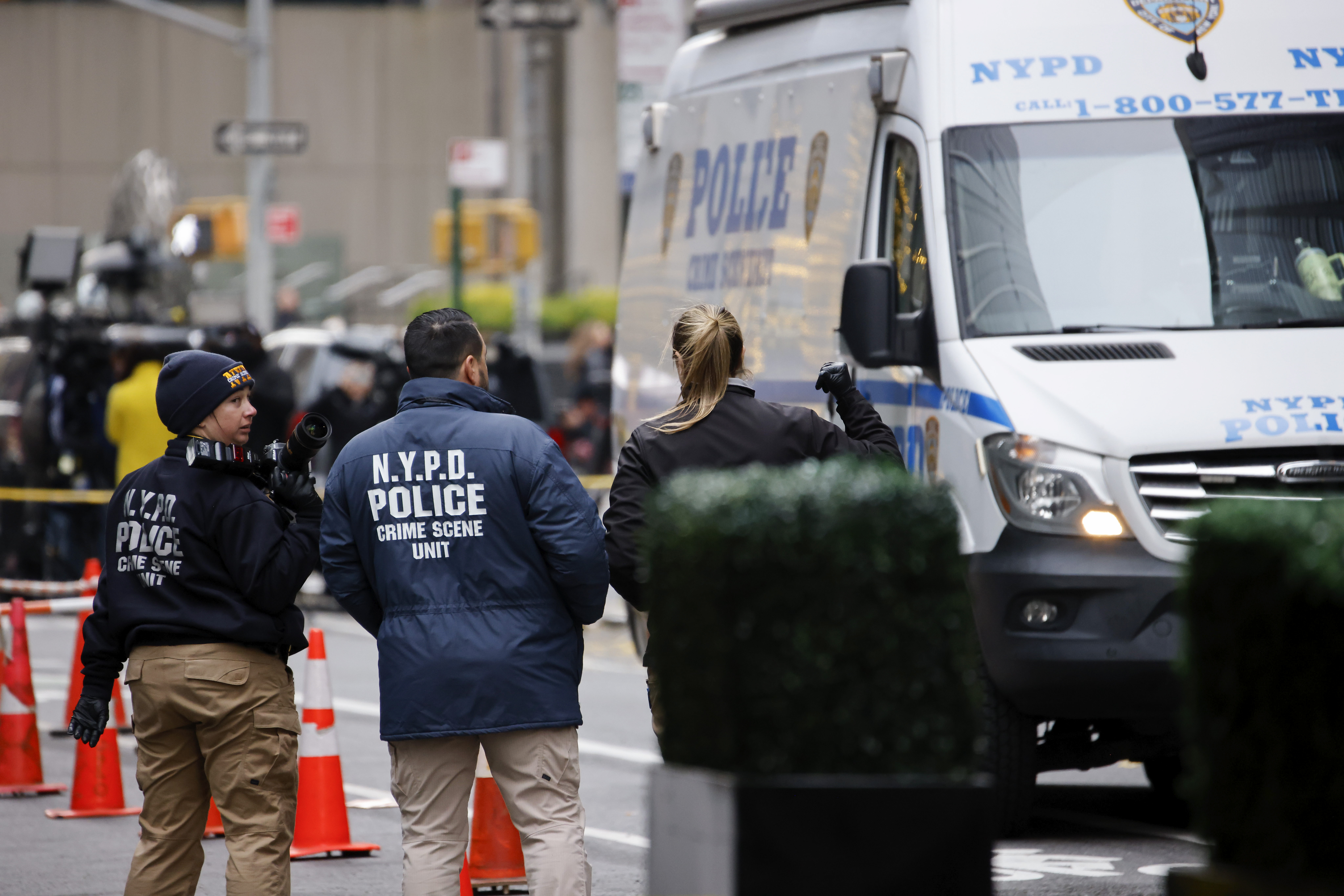 Members of the New York police crime scene unit investigate the scene outside the Hilton Hotel in midtown Manhattan where Brian Thompson, the CEO of UnitedHealthcare, was fatally shot Wednesday, Dec. 4, 2024, in New York. (AP Photo/Stefan Jeremiah)