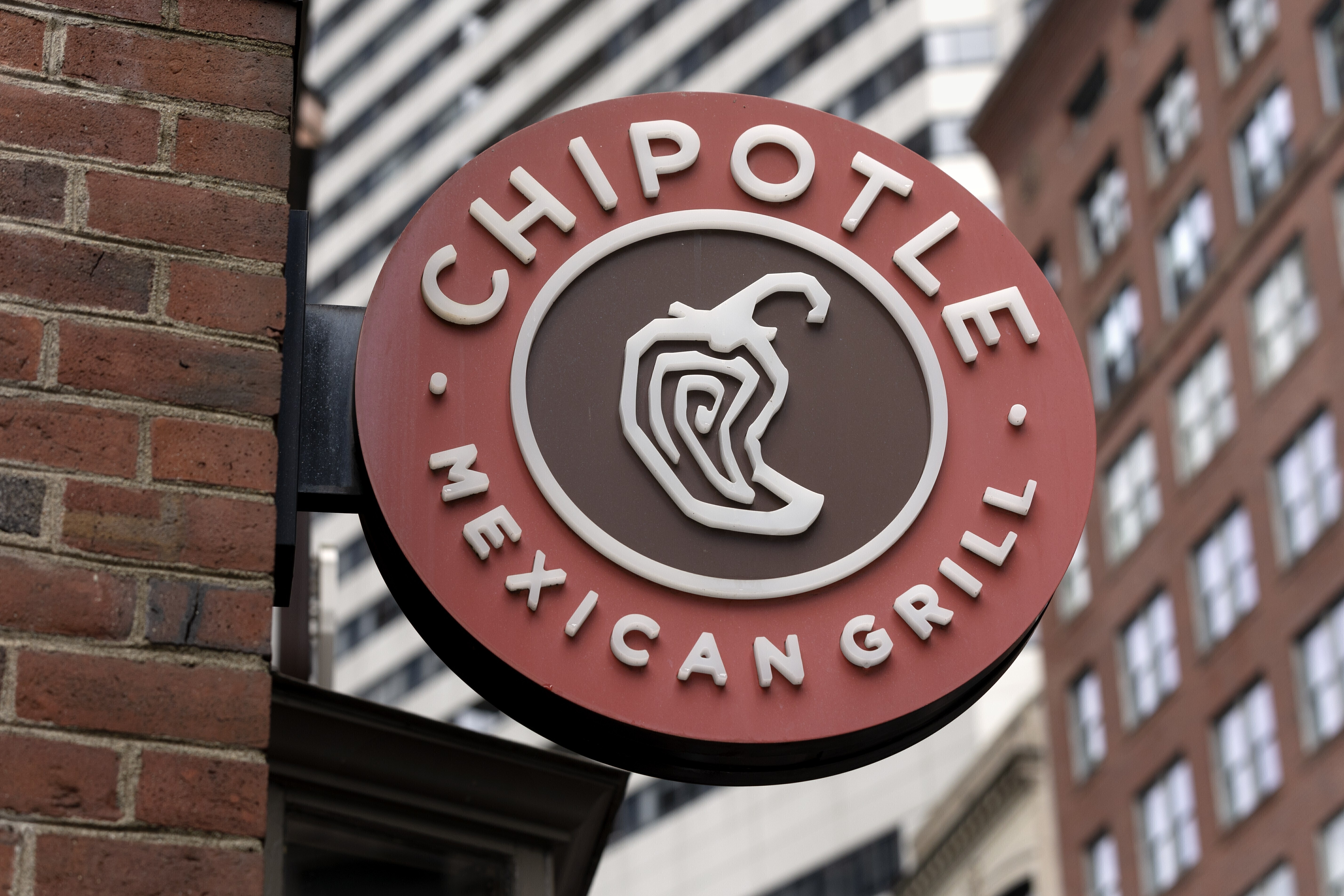 FILE - The Chipotle Mexican Grill logo is seen on a storefront, Oct. 14, 2022, in Boston. (AP Photo/Michael Dwyer, File)