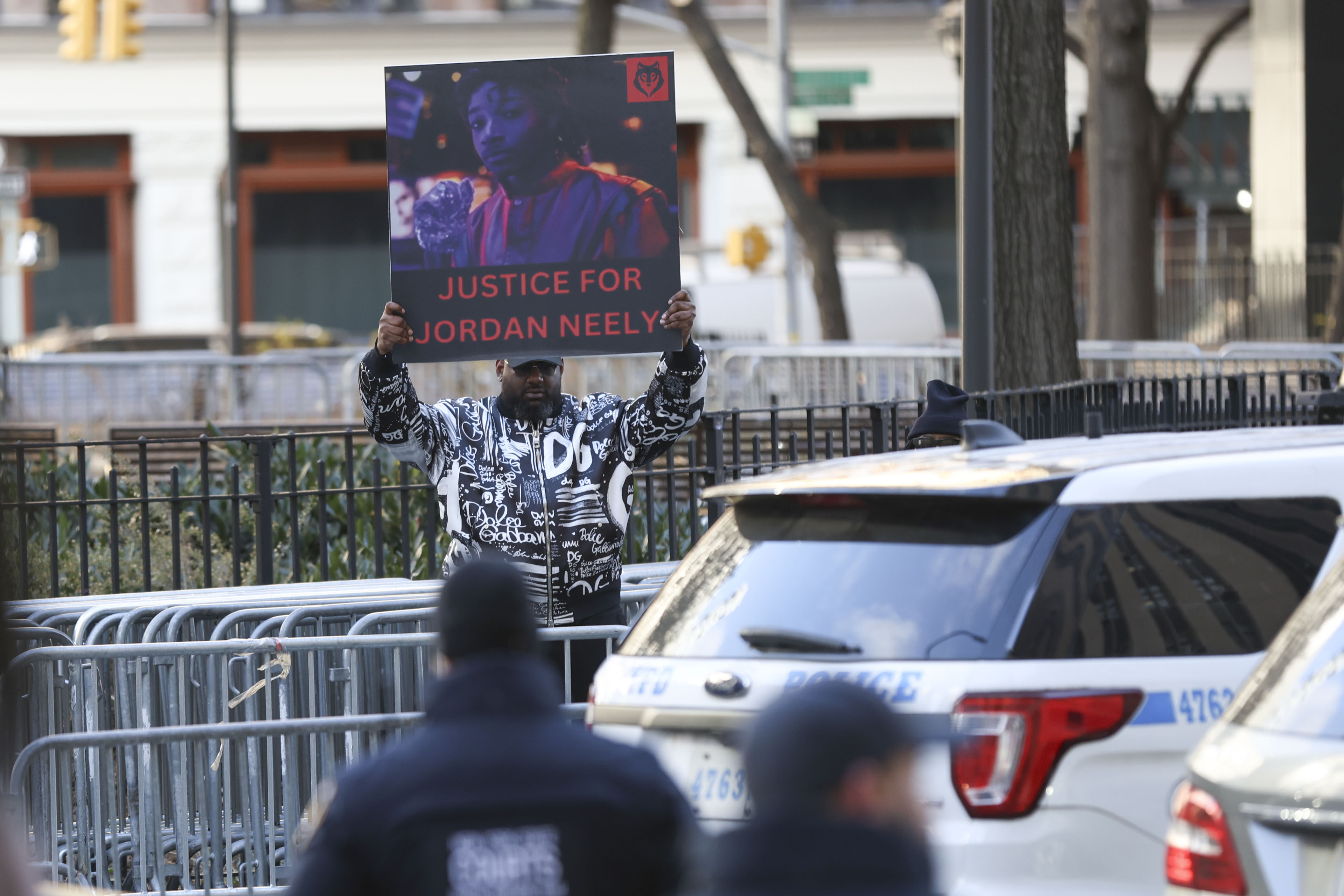 A protester holds a "Justice for Jordan Neely" sign before Daniel Penny arrives at court, Friday, Dec. 6, 2024, in New York. (AP Photo/Heather Khalifa)