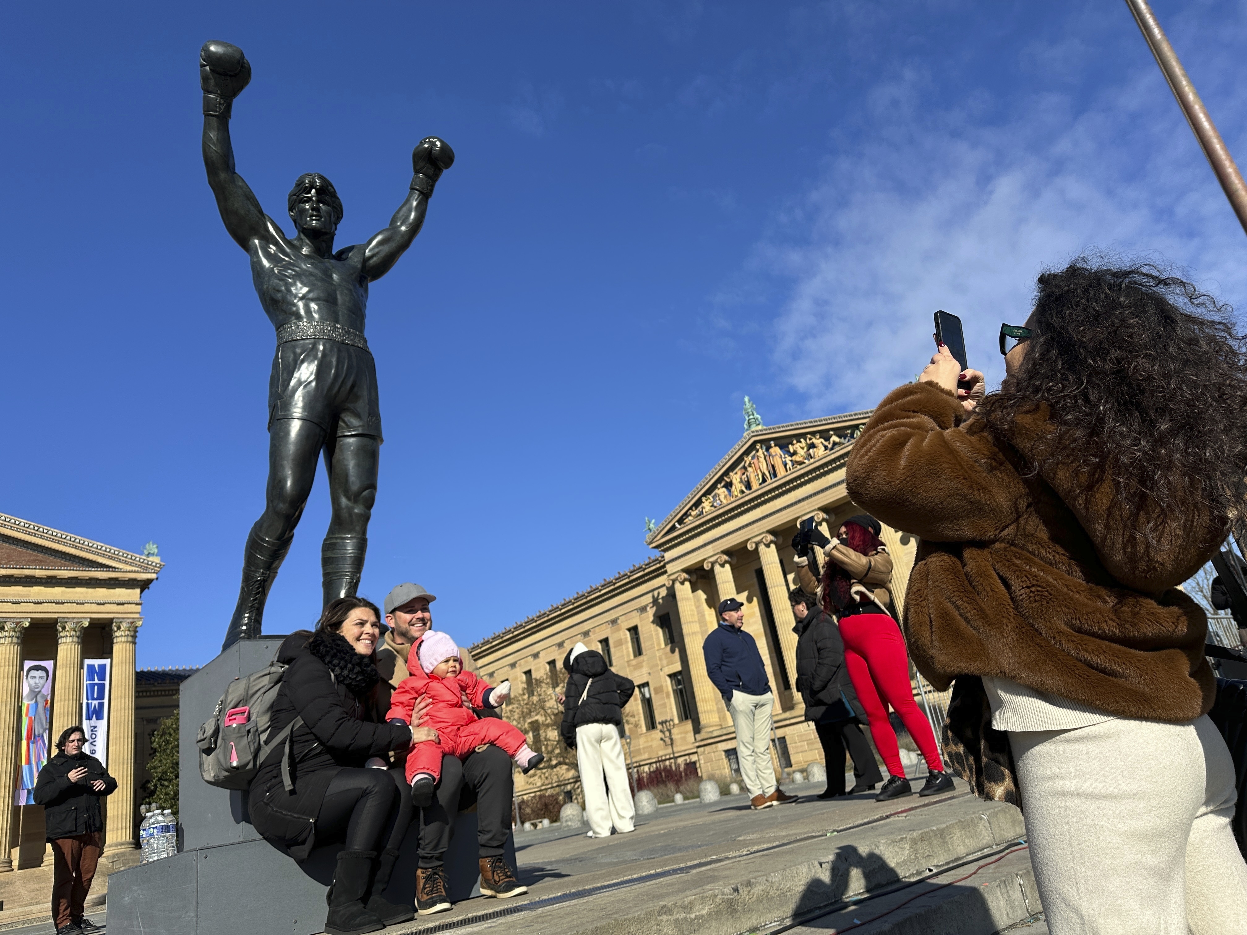 Visitors gather around the Rocky Statue and the “Rocky Steps” during RockyFest 2024 at the Philadelphia Museum of Art, Tuesday, Dec. 3, 2024, in Philadelphia. (AP Photo Tassanee Vejpongsa)