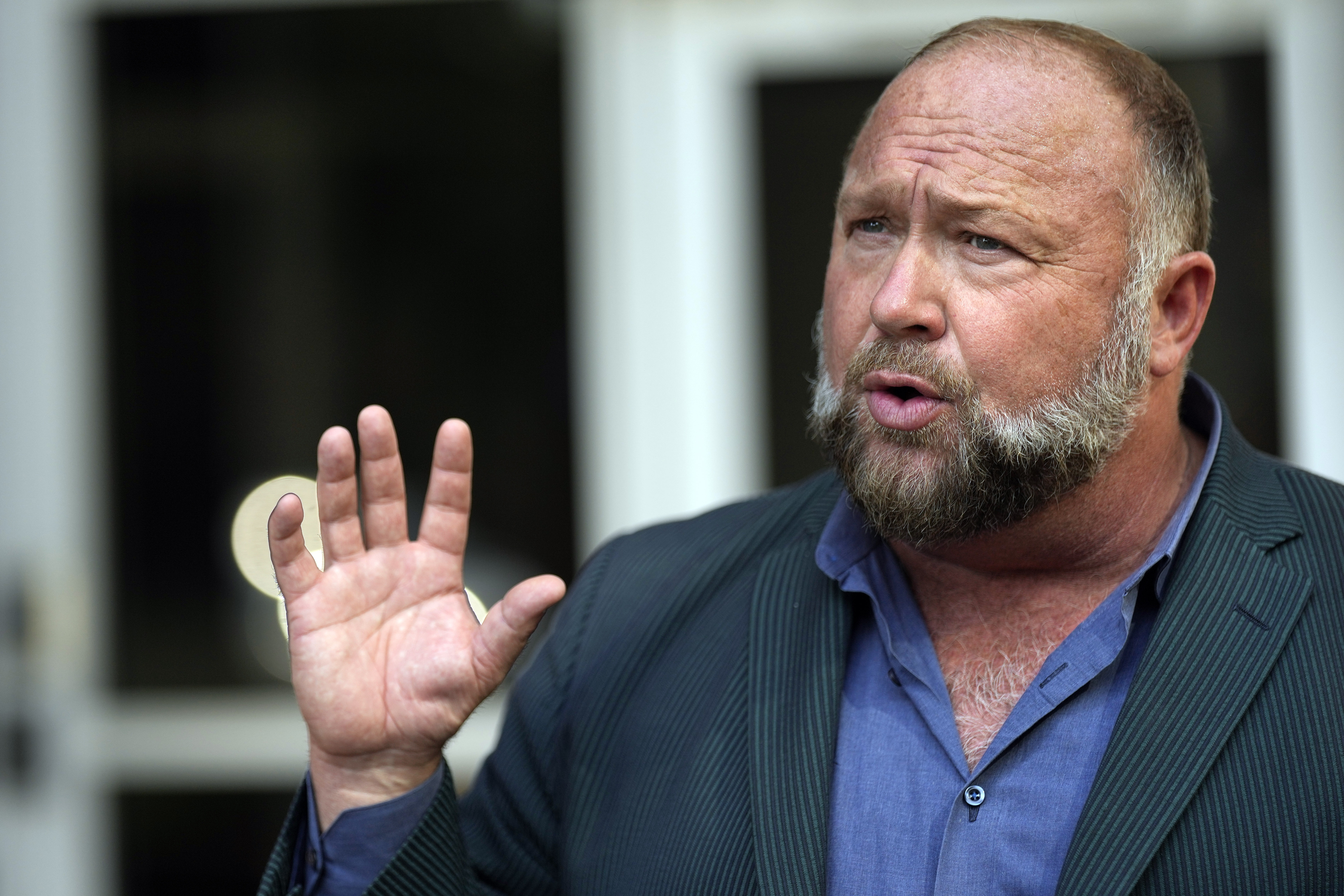 FILE - Right-wing conspiracy theorist Alex Jones speaks outside the federal courthouse after a bankruptcy hearing Friday, June 14, 2024, in Houston. (AP Photo/David J. Phillip, File)