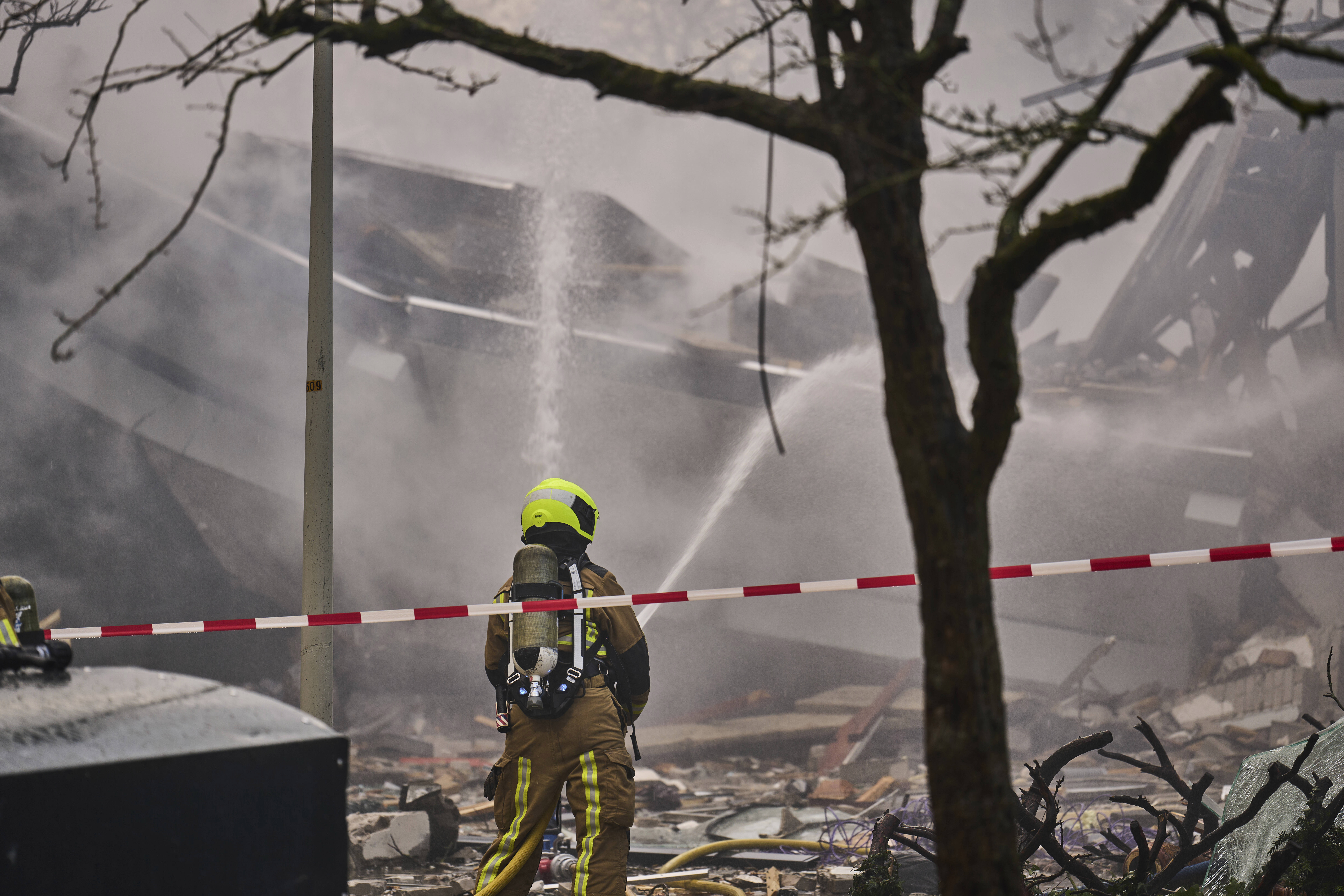 A firefighter works at the sight of an explosion at an apartment block in The Hague, Saturday, Dec. 7, 2024. (AP Photo/Phil Nijhuis)