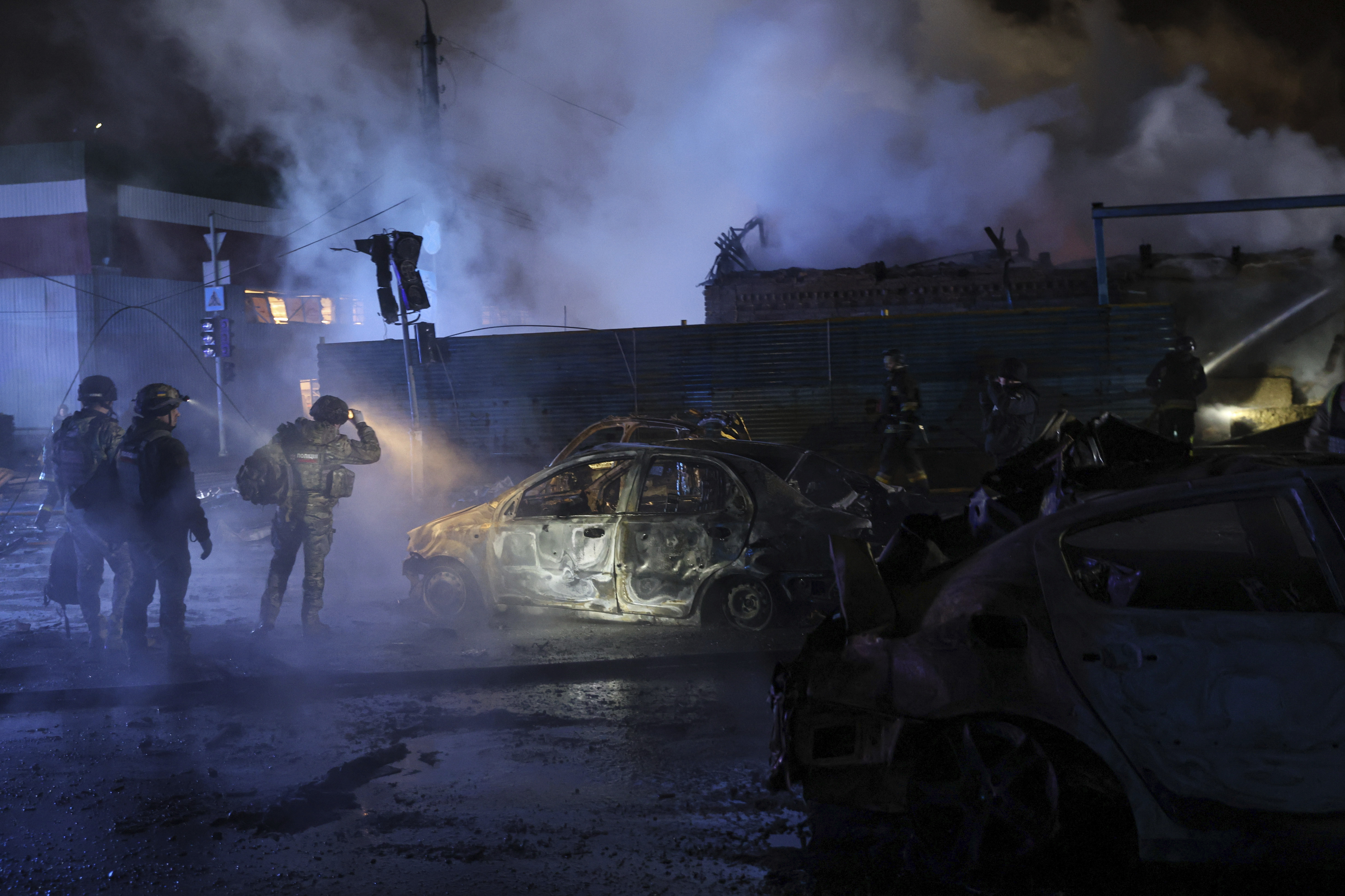 Police officers inspect cars destroyed by a Russian strike in Zaporizhzhia, Ukraine, Dec. 6, 2024. (AP Photo/Kateryna Klochko)