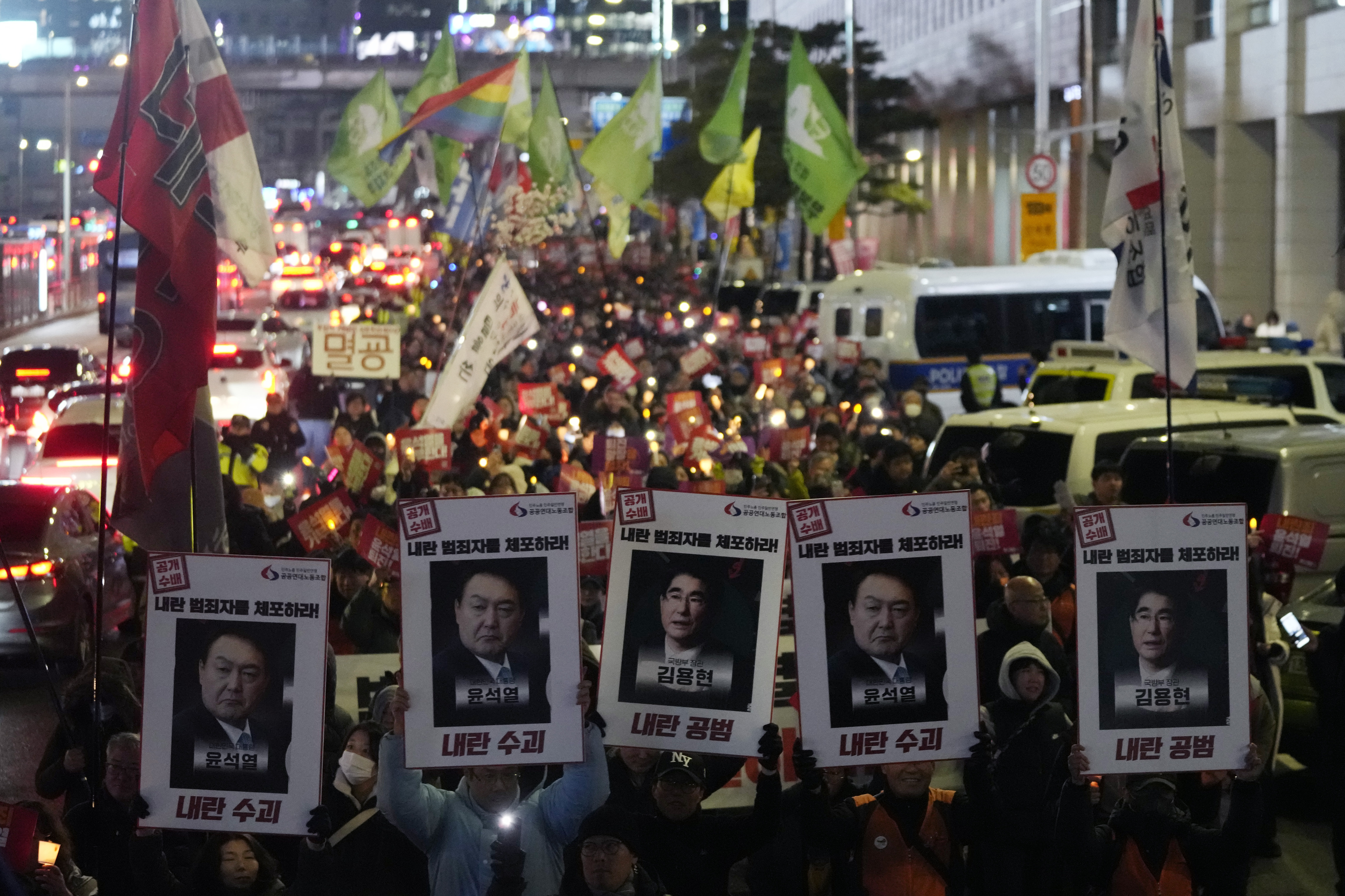 Protesters march to the presidential office after a candlelight vigil against South Korean President Yoon Suk Yeol in Seoul, South Korea, Thursday, Dec. 5, 2024. (AP Photo/Ahn Young-joon)