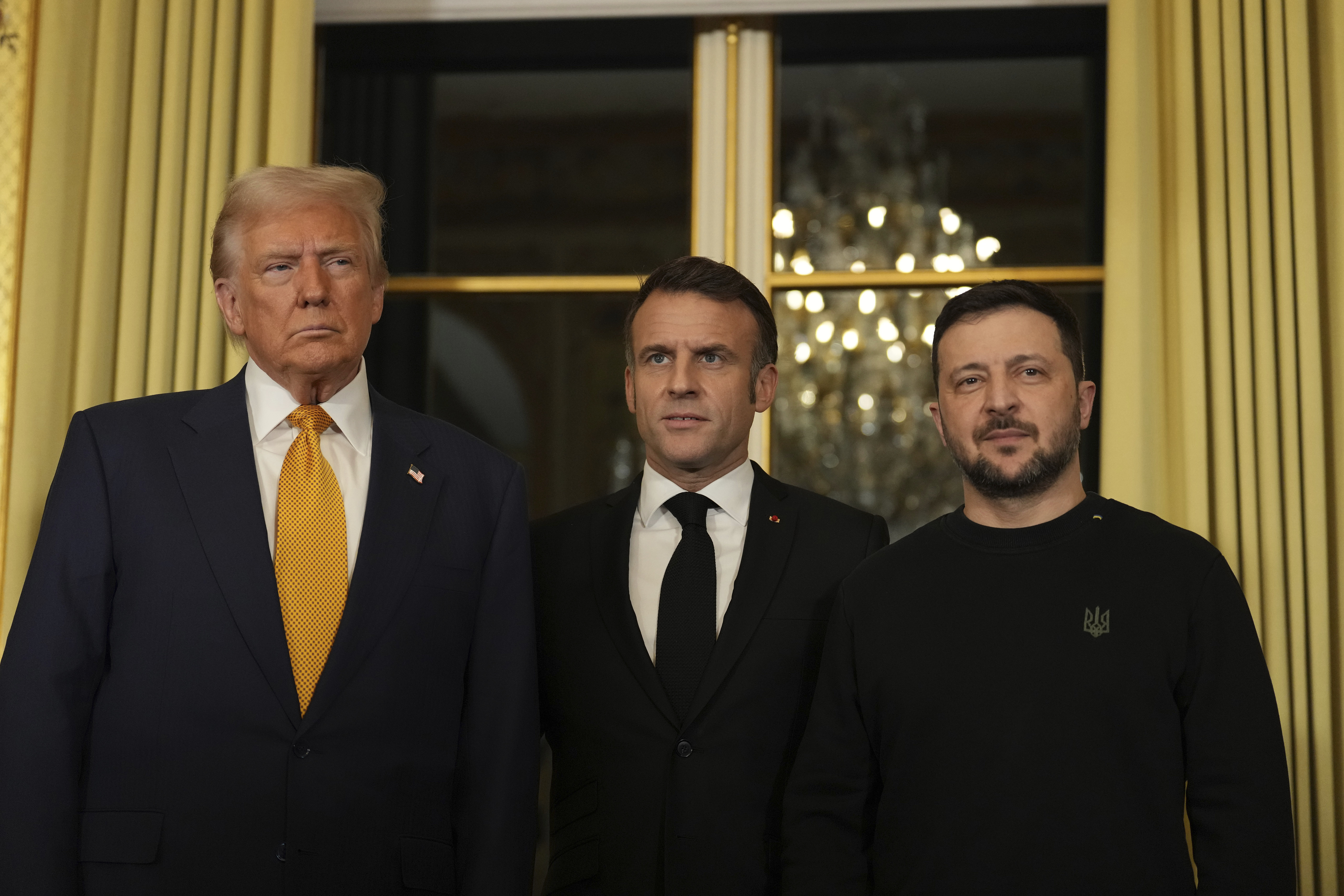 French President Emmanuel Macron, center, poses with President-elect Donald Trump, left, and Ukraine's President Volodymyr Zelenskyy at the Elysee Palace, Saturday, Dec. 7, 2024 in Paris. (AP Photo/Aurelien Morissard)