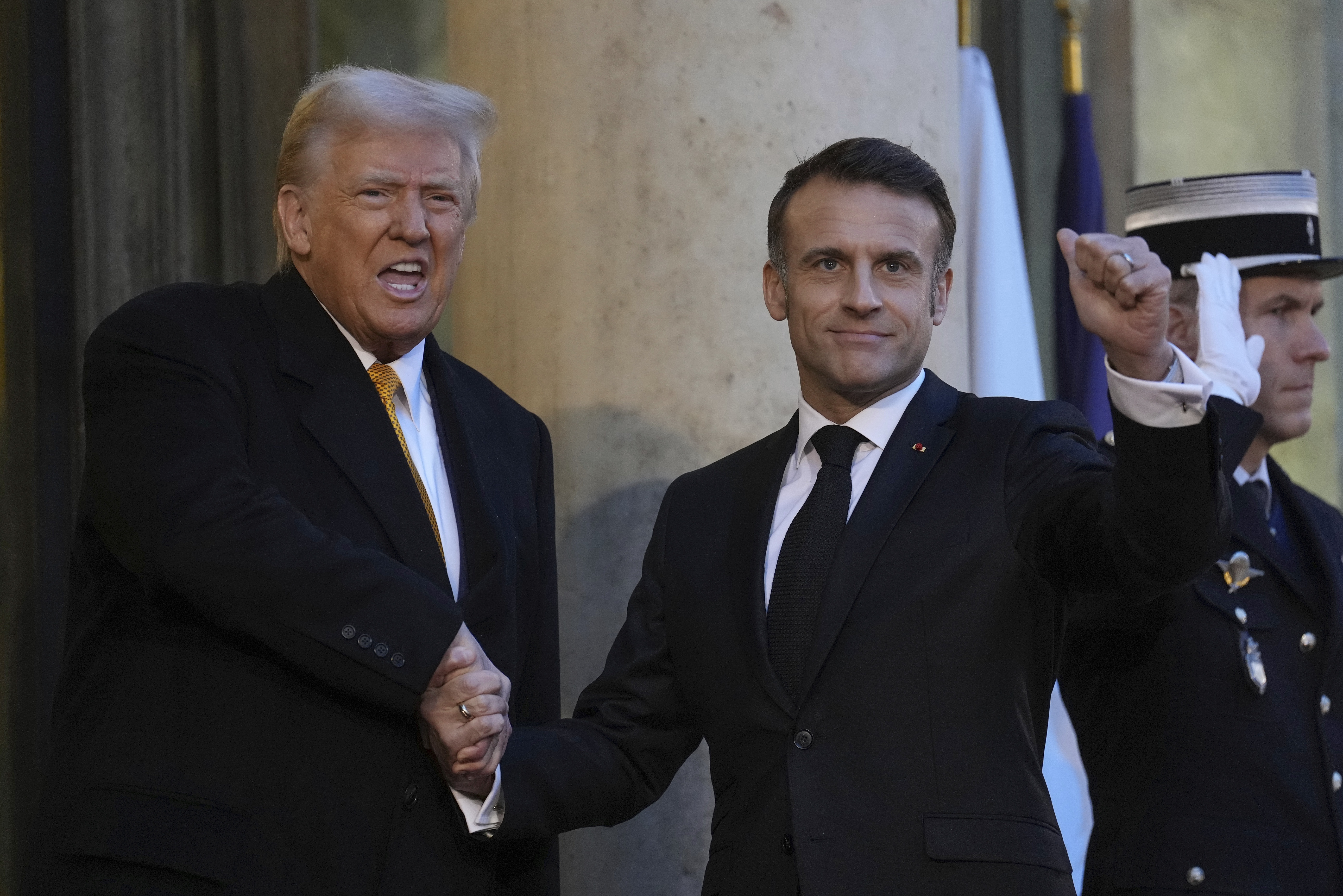 French President Emmanuel Macron welcomes President-elect Donald Trump as he arrives at the Elysee Palace, Saturday, Dec. 7, 2024 in Paris. (AP Photo/Aurelien Morissard)