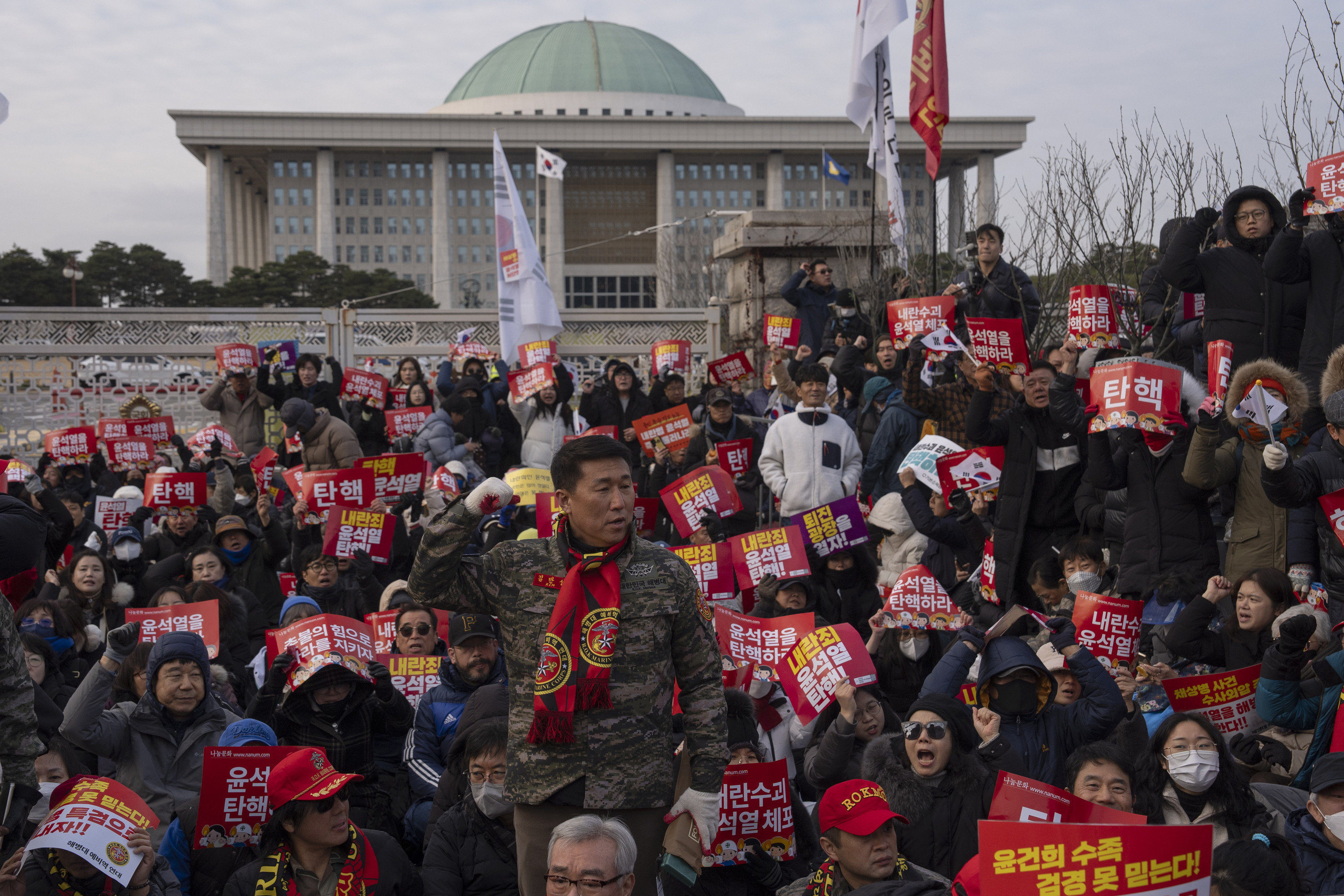 Protesters chant slogans against South Korean President Yoon Suk Yeol during a rally following the president's short-lived martial law declaration, near the National Assembly in Seoul, South Korea, Saturday, Dec. 7, 2024. (AP Photo/Ng Han Guan)