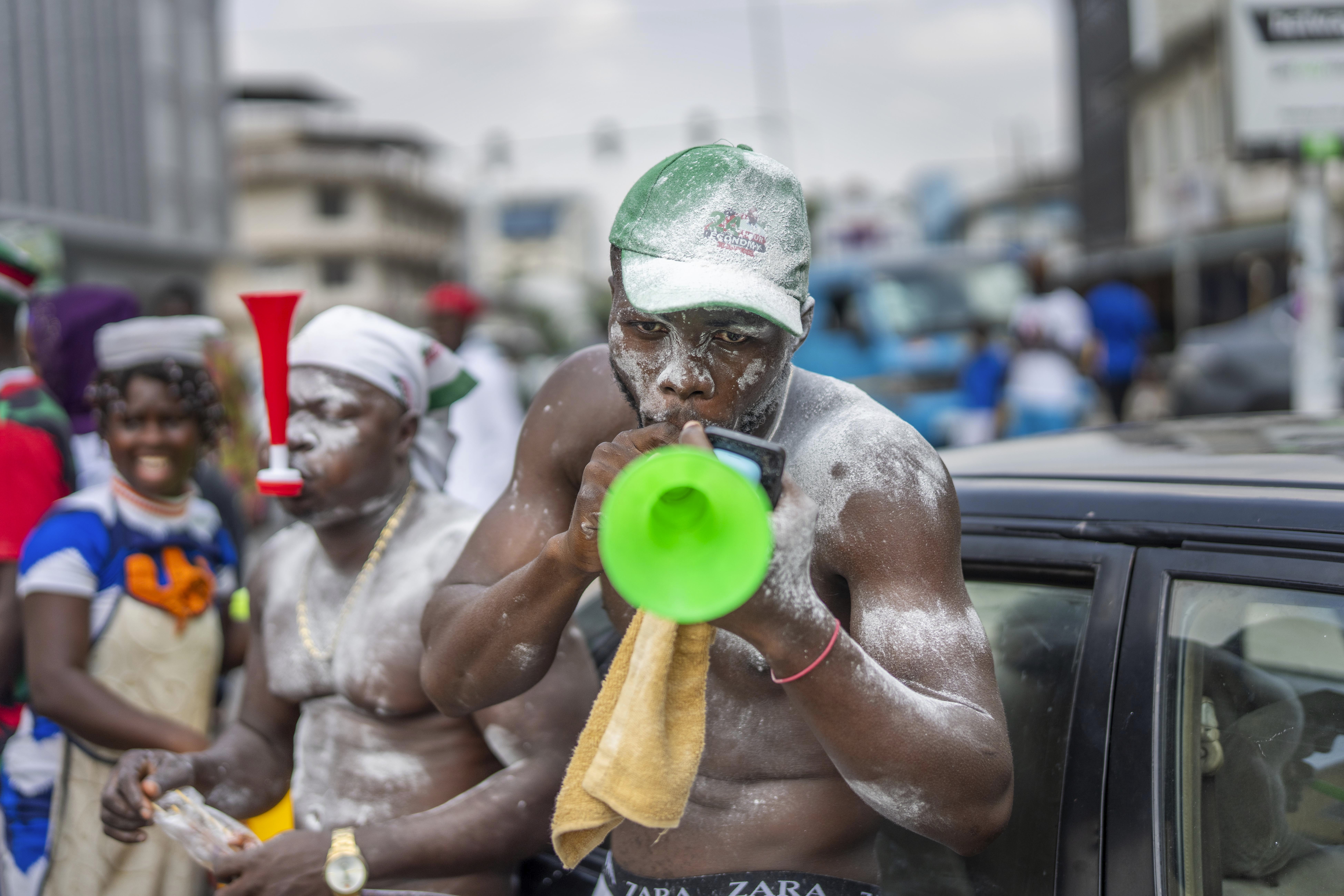 Supporters of opposition candidate and former President John Dramani Mahama celebrate his victory after his opponent Ghana’s vice president and ruling party candidate, Mahamudu Bawumia conceded in Accra, Ghana, Sunday, Dec. 8, 2024. (AP Photo/Jerome Delay)