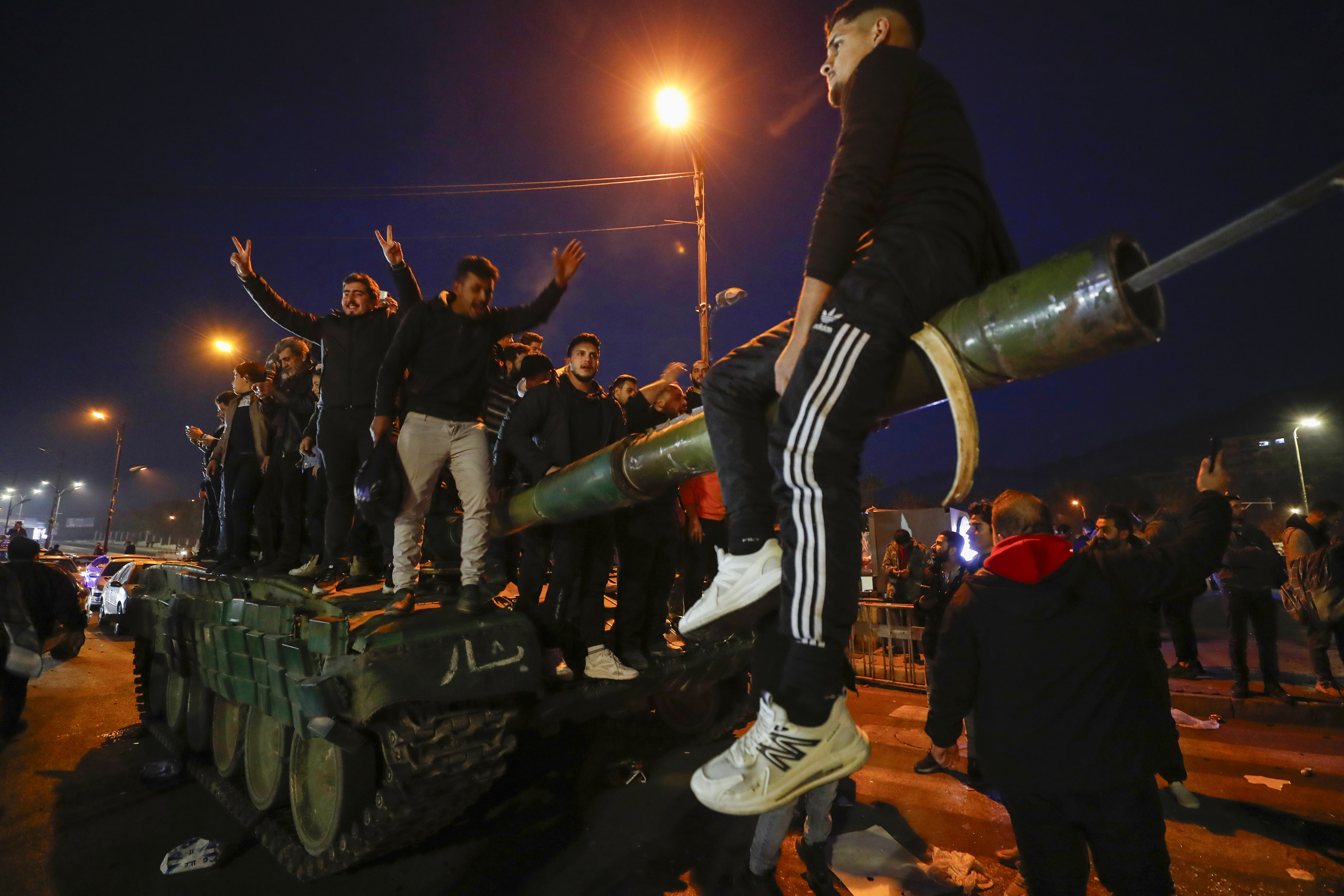 Syrians celebrate the arrival of opposition fighters in Damascus, Syria, Sunday, Dec. 8, 2024. (AP Photo/Omar Sanadiki)