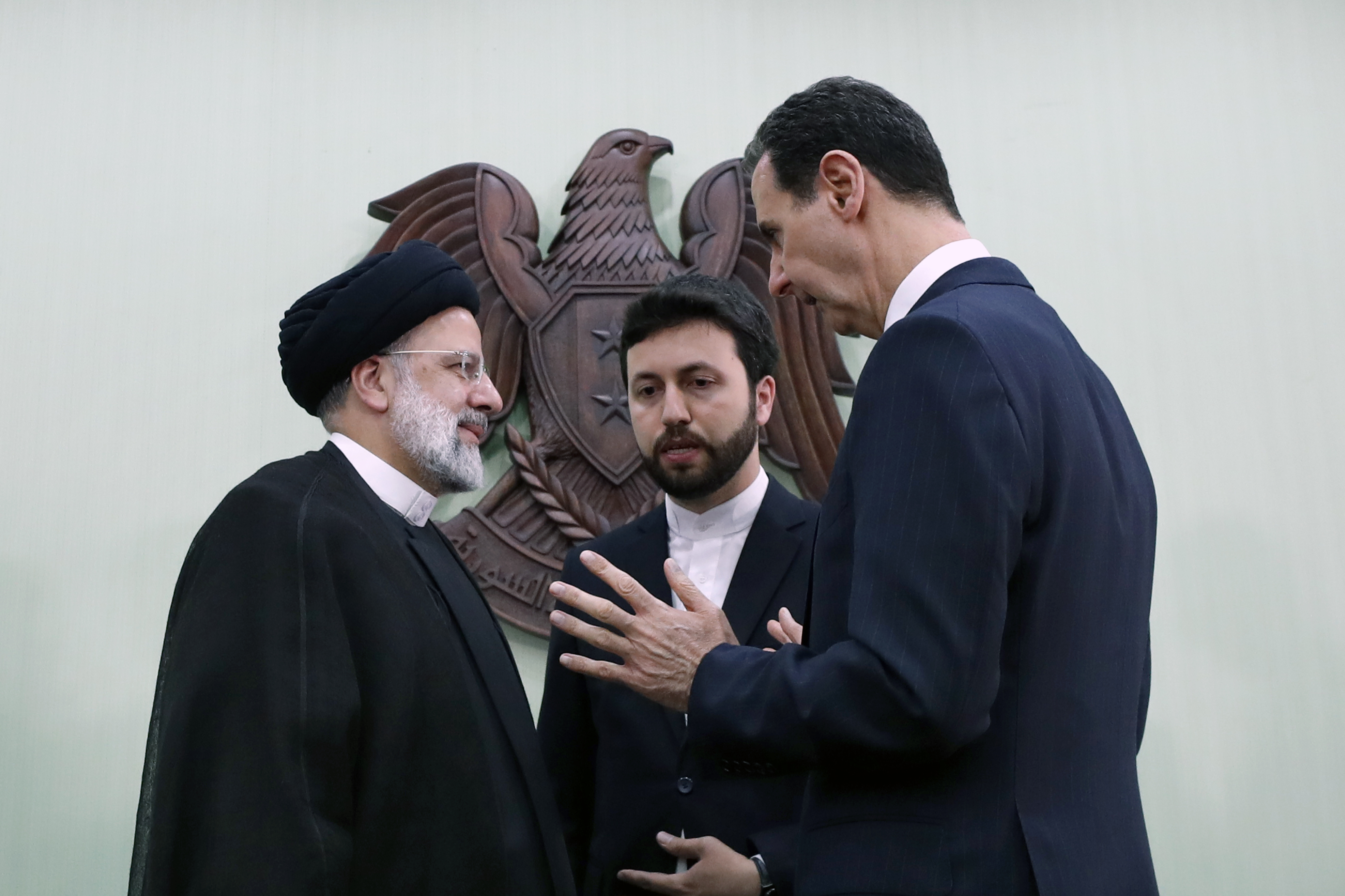 FILE - Syrian President Bashar Assad, right, speaks with Iranian President Ebrahim Raisi, left, in Damascus, Syria, May 3, 2023. (AP Photo/Omar Sanadiki, File)