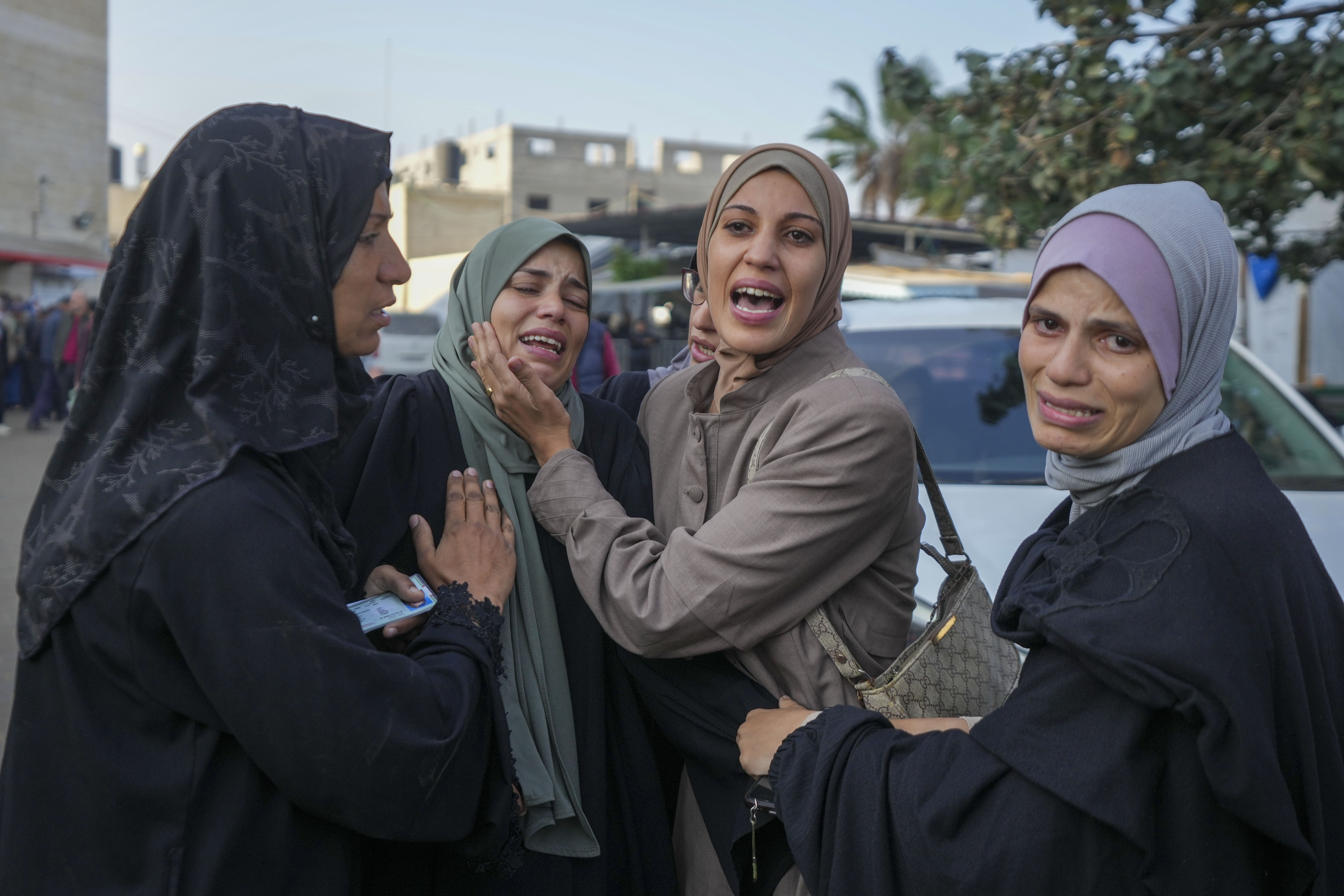 Palestinian women mourn over victims following an Israeli bombardment, at the Al-Aqsa Martyrs hospital in Deir al-Balah, Gaza Strip, Sunday, Dec. 8, 2024. (AP Photo/Abdel Kareem Hana)