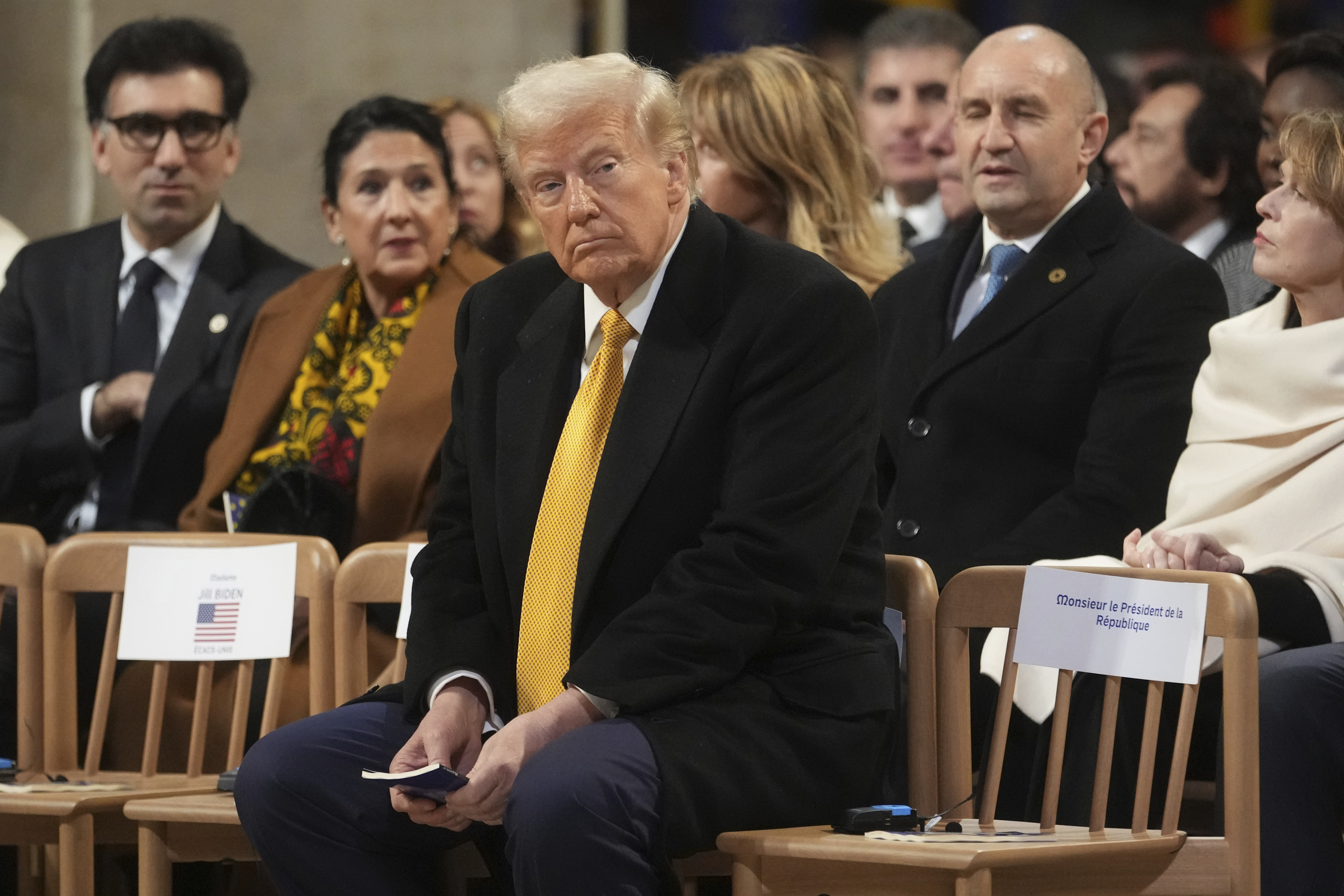 President-elect Donald Trump sits in Notre Dame Cathedral as France's iconic cathedral is formally reopening its doors for the first time since a devastating fire nearly destroyed the 861-year-old landmark in 2019, Saturday, Dec. 7, 2024 in Paris. (AP Photo/Thibault Camus, Pool)