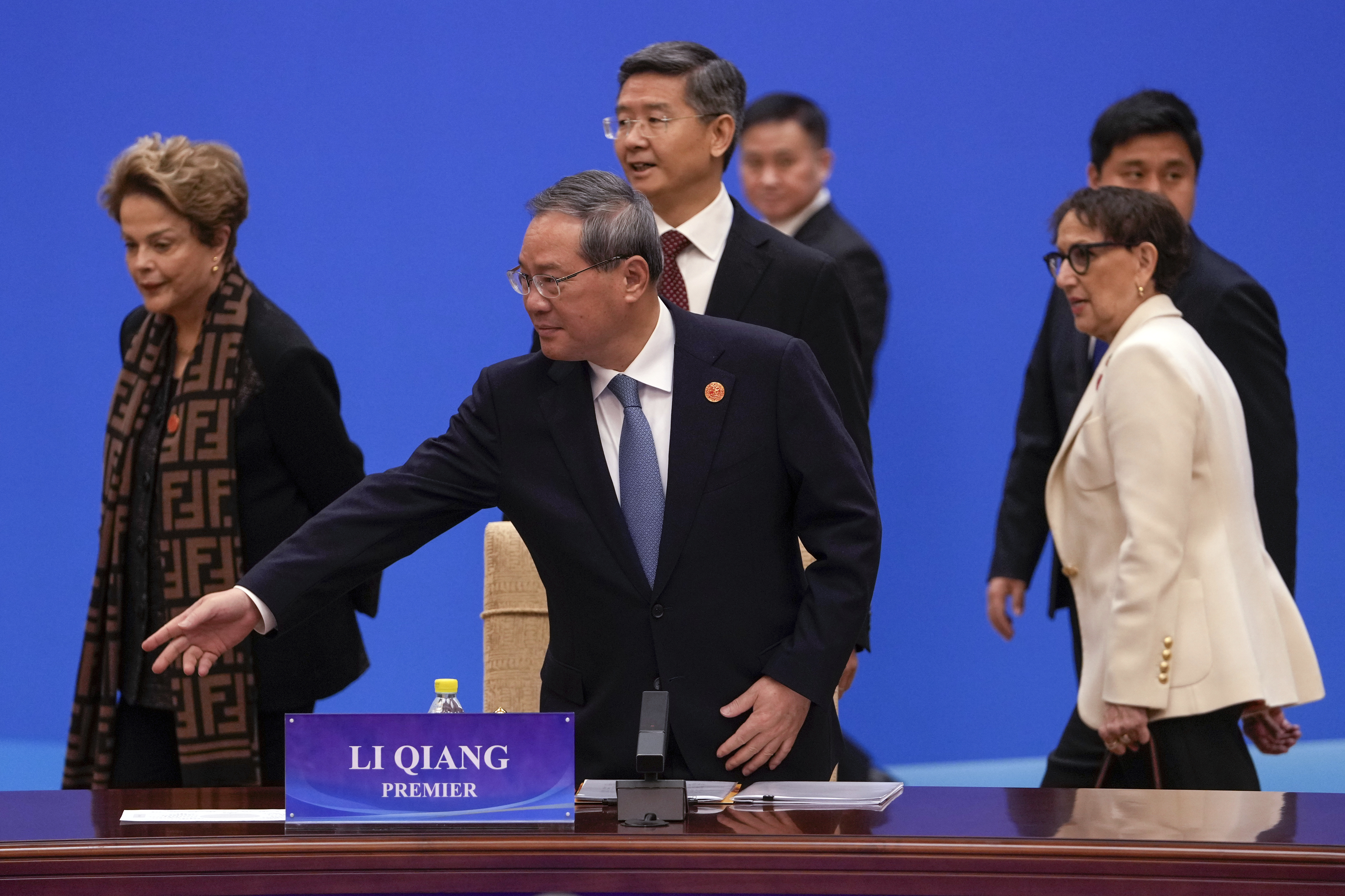 Chinese Premier Li Qiang, center, gestures as President of the New Development Bank Dilma Rousseff, left, and Rebeca Grynspan, right, secretary-general of the United Nations Conference on Trade and Development (UNCTAD), arrive at the "1+10" Dialogue on Building Consensus on Development to Promote Global Common Prosperity, at the Diaoyutai State Guesthouse in Beijing, Monday, Dec. 9, 2024. (AP Photo/Andy Wong)