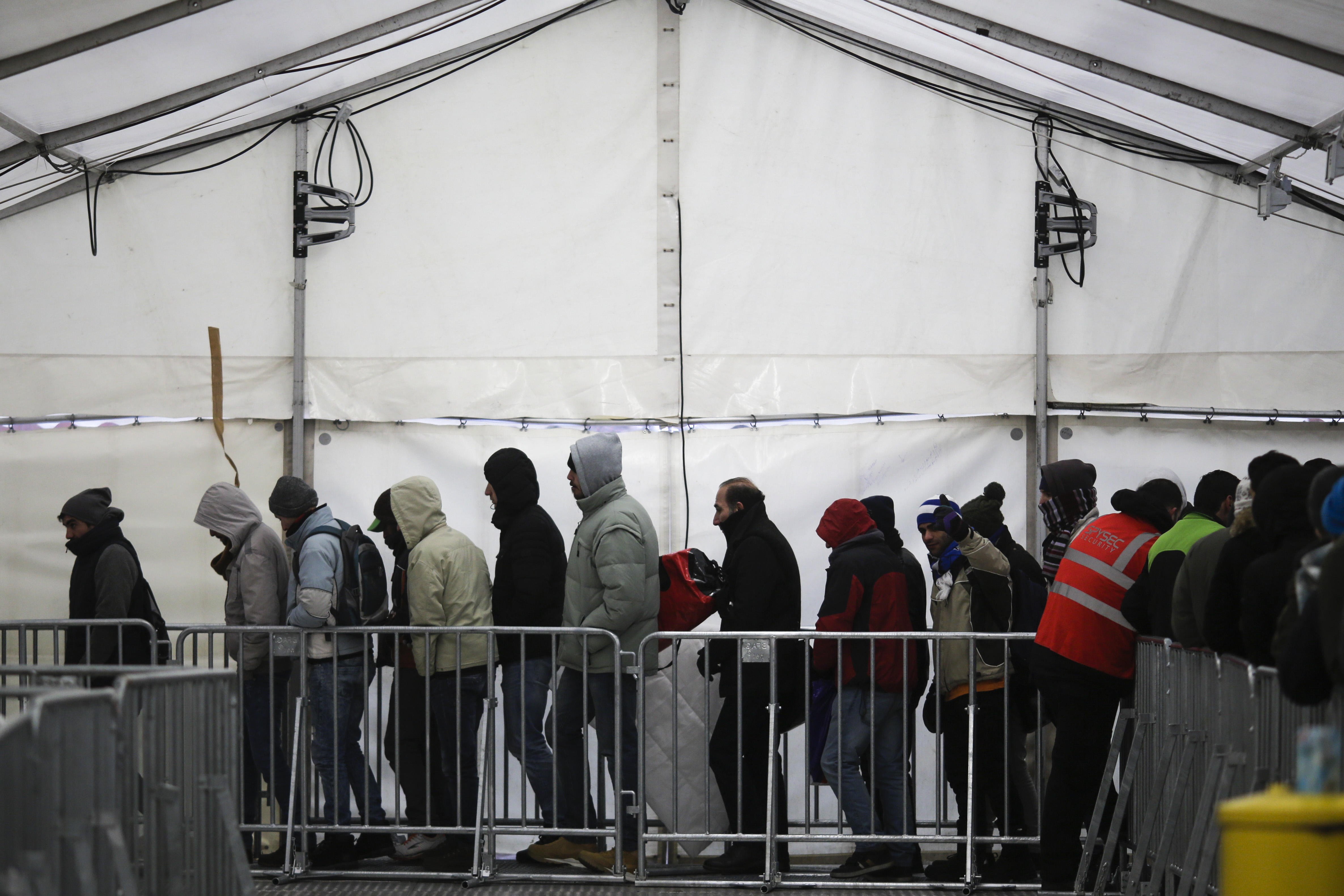 FILE - Migrants and refugees line up at the central registration center for refugees and asylum seekers LaGeSo (Landesamt fuer Gesundheit und Soziales - State Office for Health and Social Affairs) LaGeSo in Berlin, Germany, Monday, Jan. 4, 2016. (AP Photo/Markus Schreiber, File)