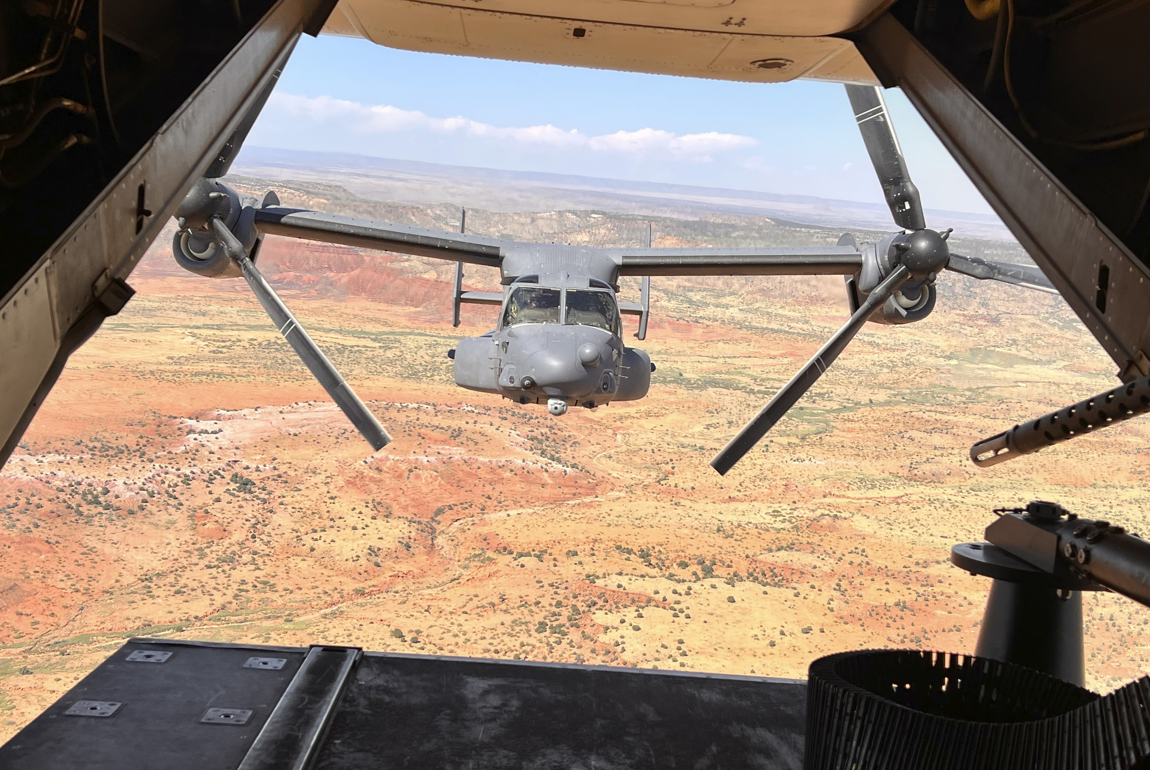 Two Air Force Special Operations Command CV-22B Ospreys fly low and fast in formation on a training range named the Hornet at Cannon Air Force Base, N.M., Oct. 9, 2024. (AP Photo/Tara Copp)