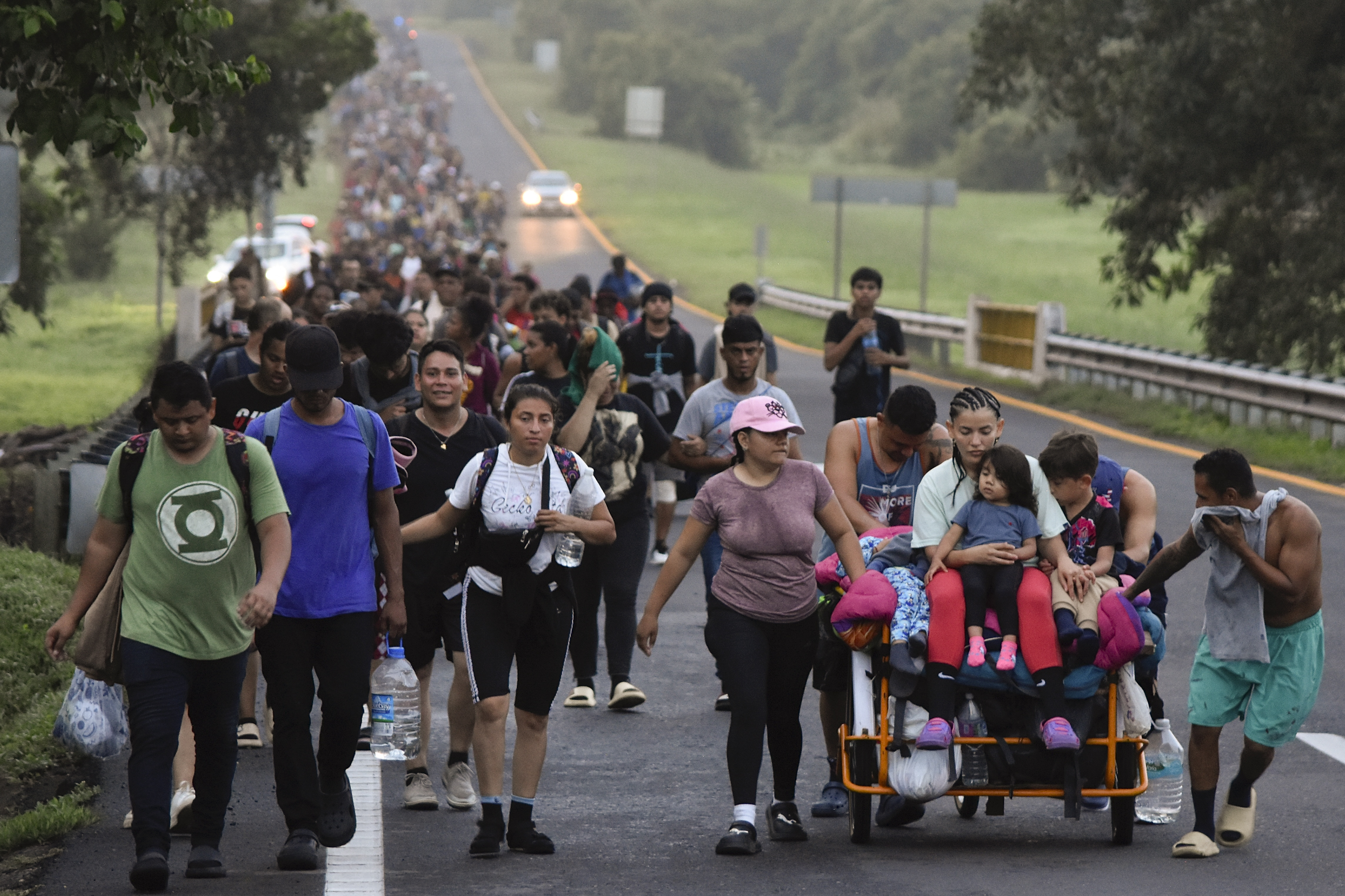 FILE - Migrants walk along the Huixtla highway in the state of Chiapas, Mexico, Oct. 22, 2024, hoping to reach the country's northern border and ultimately the United States. (AP Photo/Edgar H. Clemente, File)