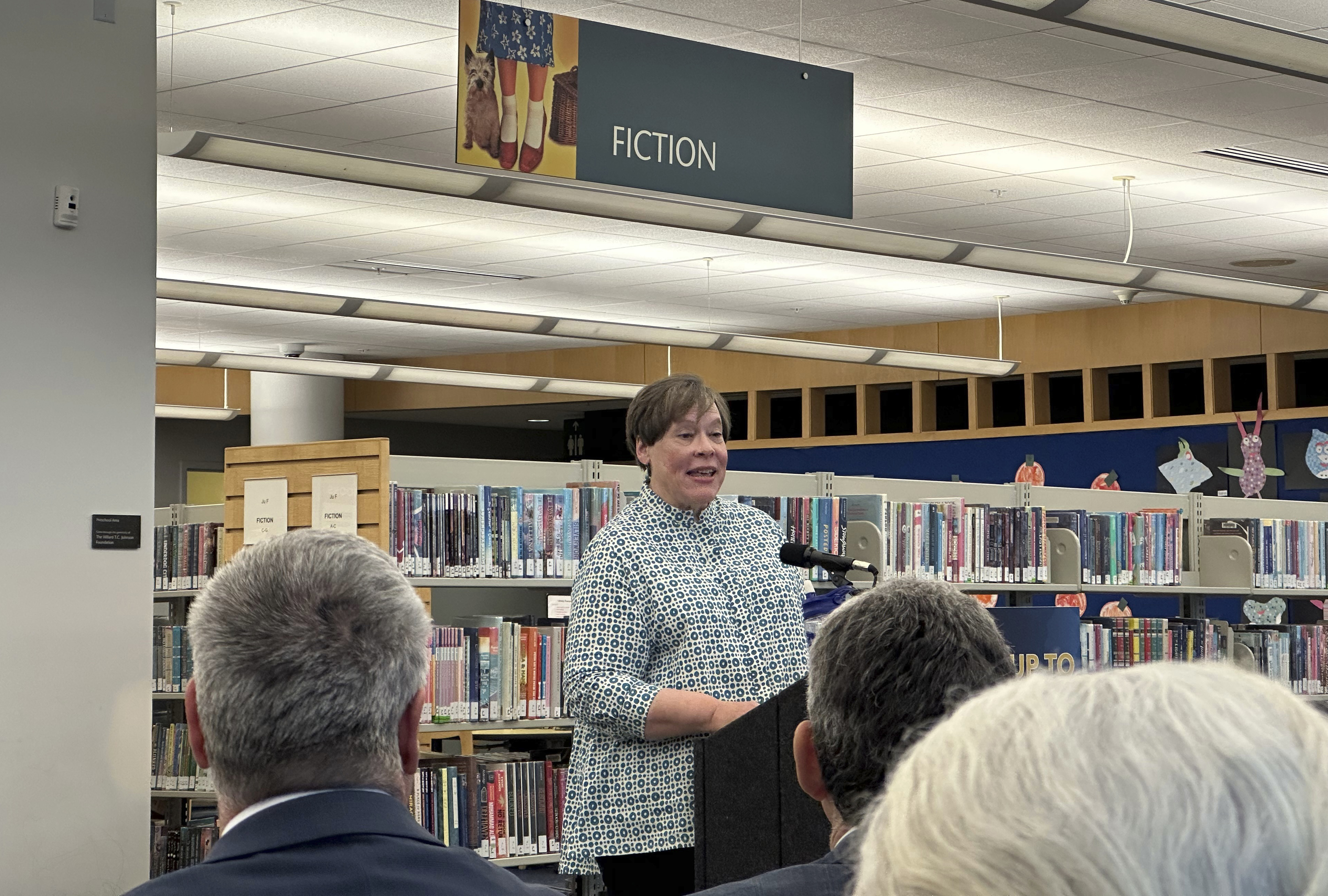 Retired librarian Martha Hickson speaks at Princeton Public Library on Monday, Dec. 9, 2024, where Gov. Phil Murphy was set to sign a bill aimed at prohibiting bans on books in schools and public libraries. (AP Photo/Mike Catalini)