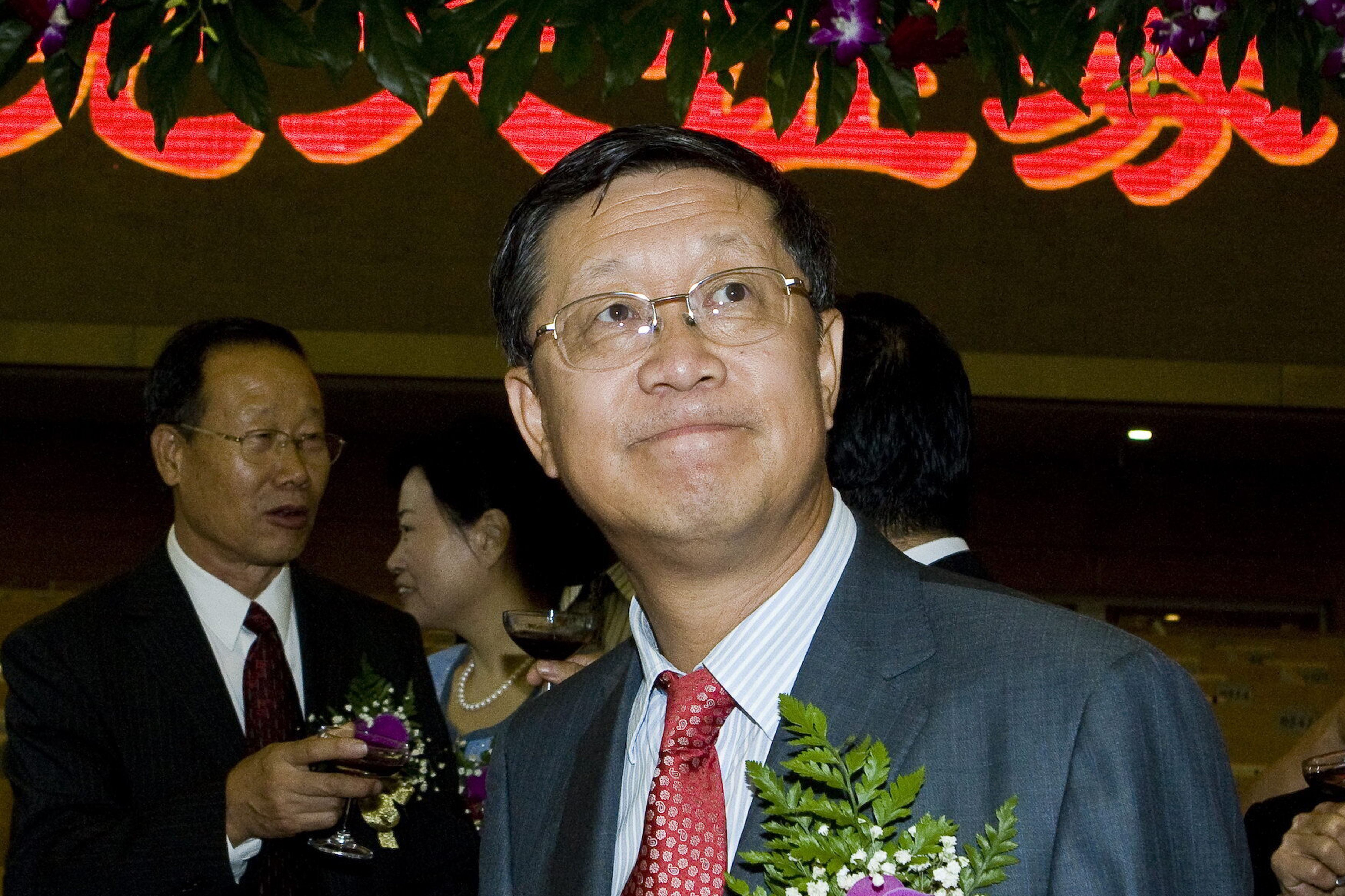 FILE - Tang Shuangning, right, then chairman of China Everbright Group and Everbright Securities Co., is pictured after toasting the IPO for Everbright Securities at Shanghai Stock Exchange in Shanghai, China on Aug. 18, 2009.(Chinatopix via AP, File)