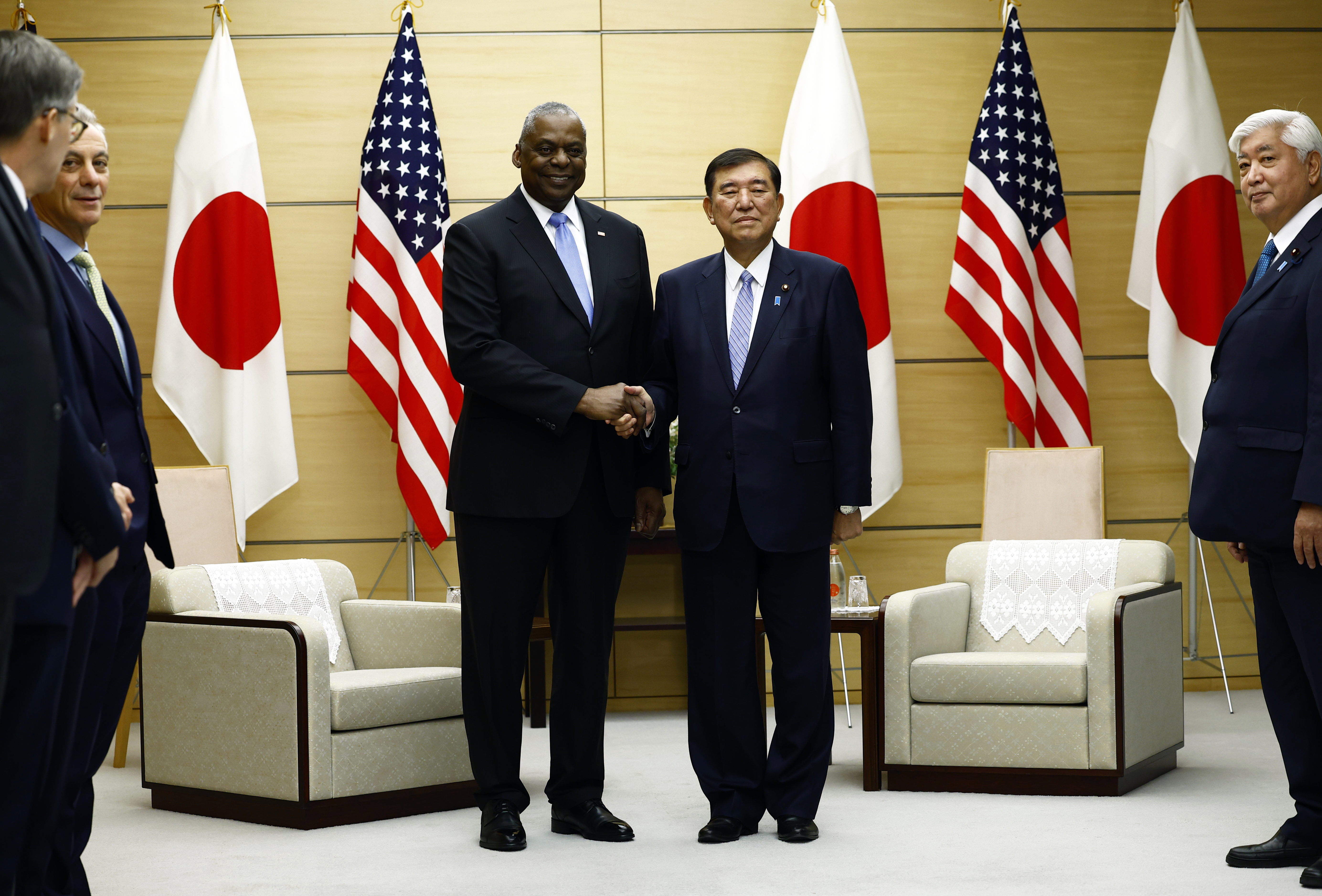 U.S. Defense Secretary Lloyd Austin, left, shakes hands with Japan's Prime Minister Shigeru Ishiba at the start of their bilateral meeting at the prime minister's official residence in Tokyo, Japan, Tuesday, Dec. 10, 2024.(Issei Kato/Pool Photo via AP)