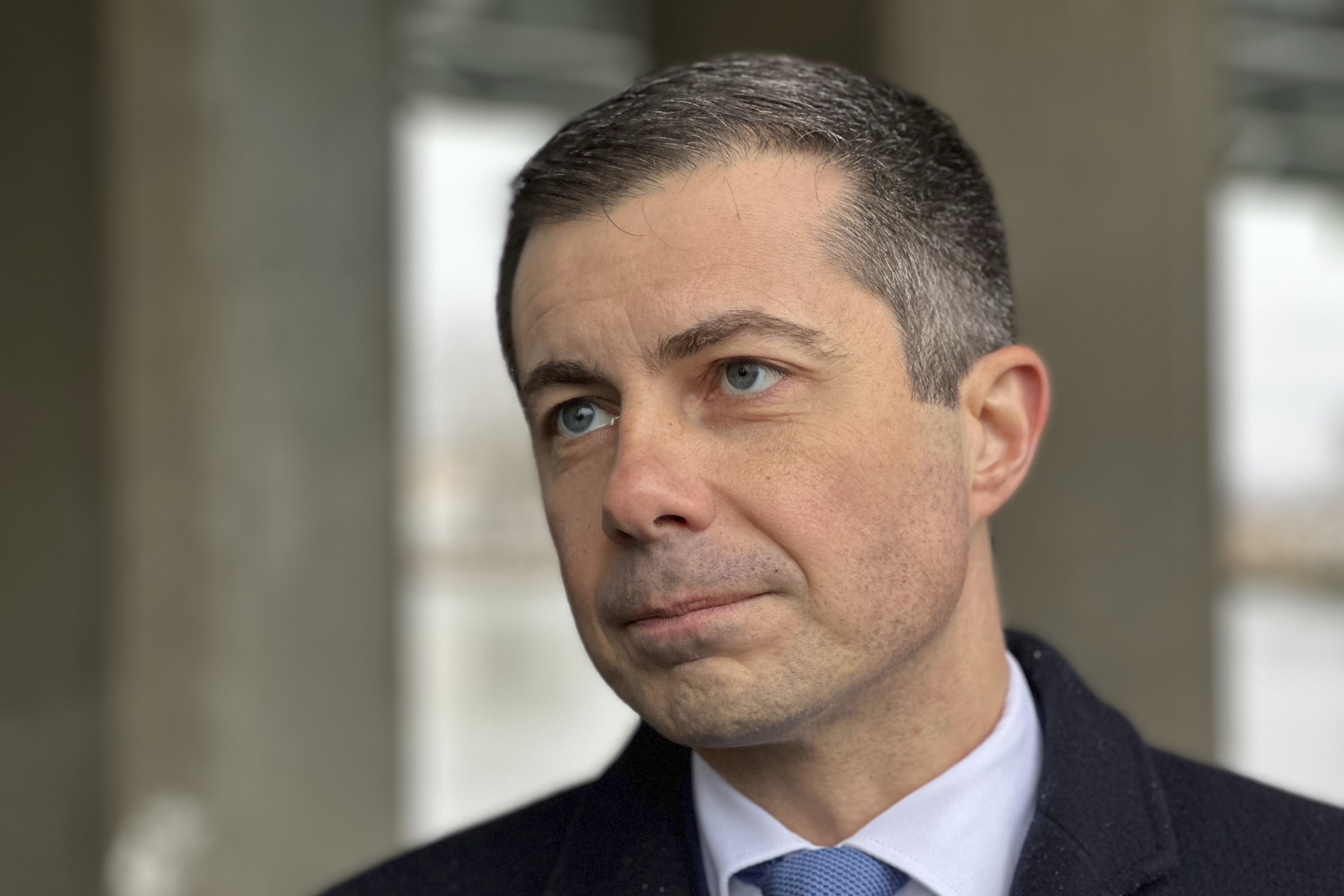 Transportation Secretary Pete Buttigieg speaks to an Associated Press reporter during an interview Monday, Dec. 9, 2024, in Monroe, Mich. (AP Photo/Mike Householder)