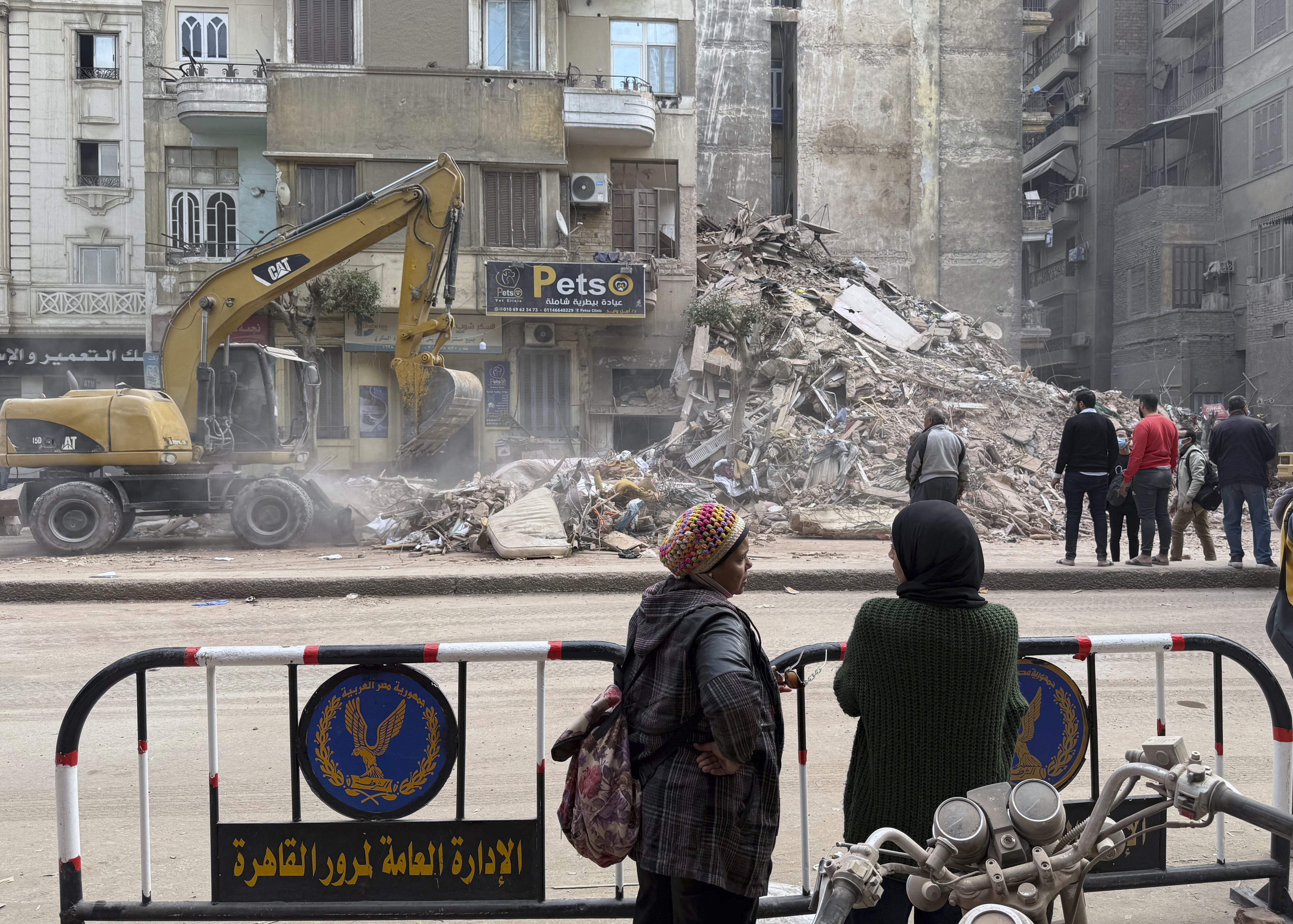 Rescuers search through the rubble of a collapsed six-story apartment building in Cairo, Egypt, Tuesday Dec. 10, 2024 (AP Photo/ Khaled Elfiqi)