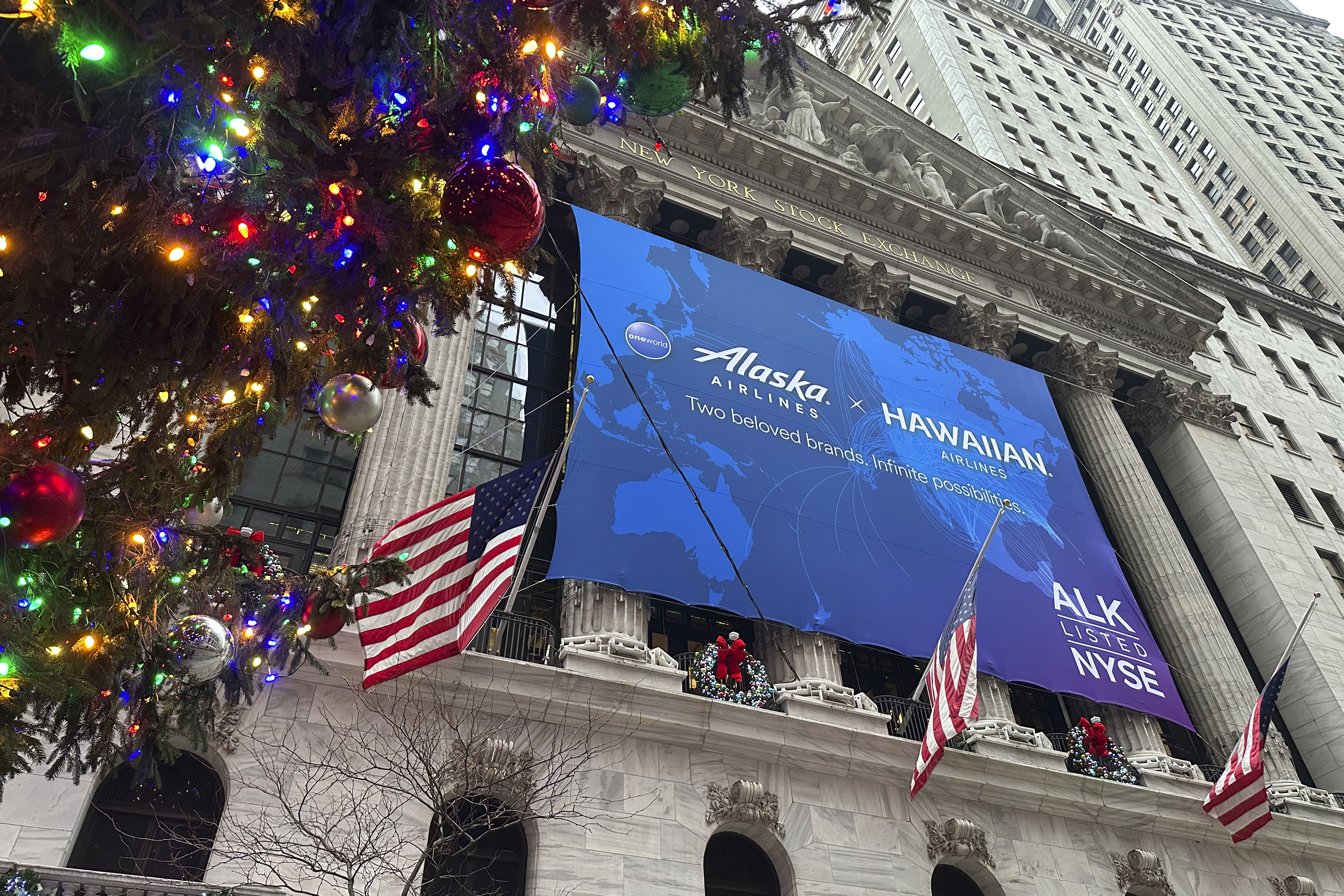 A banner for Alaska Air Group hangs on the front of the New York Stock Exchange in New York's Financial District on Tuesday, Dec. 10, 2024. (AP Photo/Peter Morgan, File)