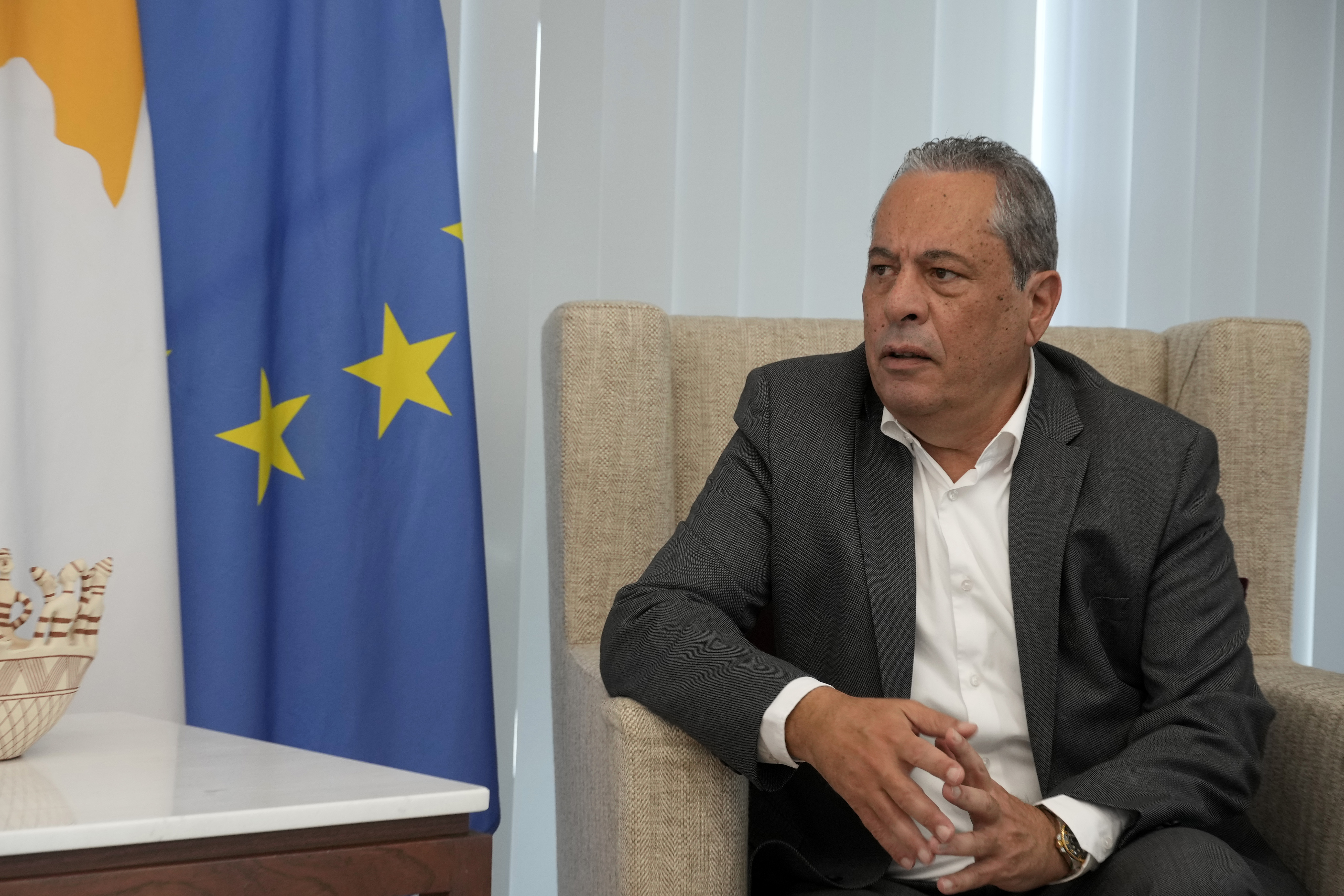 Minister of Defence Vasilis Palmas talks during an interview with the Associated Press at his office in the Defence ministry in divided capital Nicosia, Cyprus, Tuesday, Dec. 10, 2024. (AP Photo/Petros Karadjias)