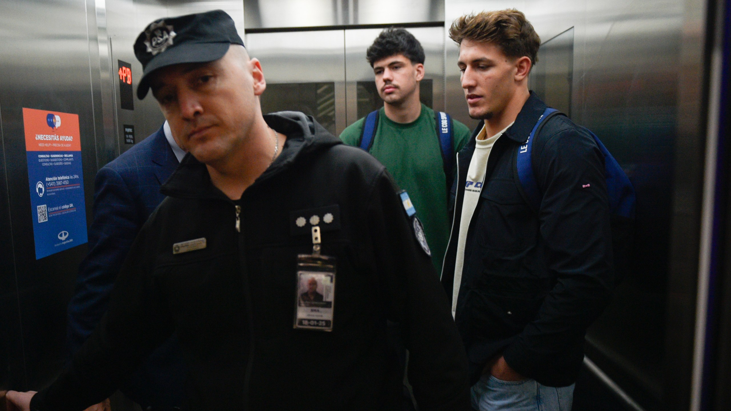 FILE - French rugby players Oscar Jegou, right, and Hugo Auradou, center, stand inside an elevator at the airport in Buenos Aires, Argentina, Sept. 3, 2024, after prosecutors decided to let the player leave the country despite remaining under investigation for alleged rape. (AP Photo/Gustavo Garello, File)