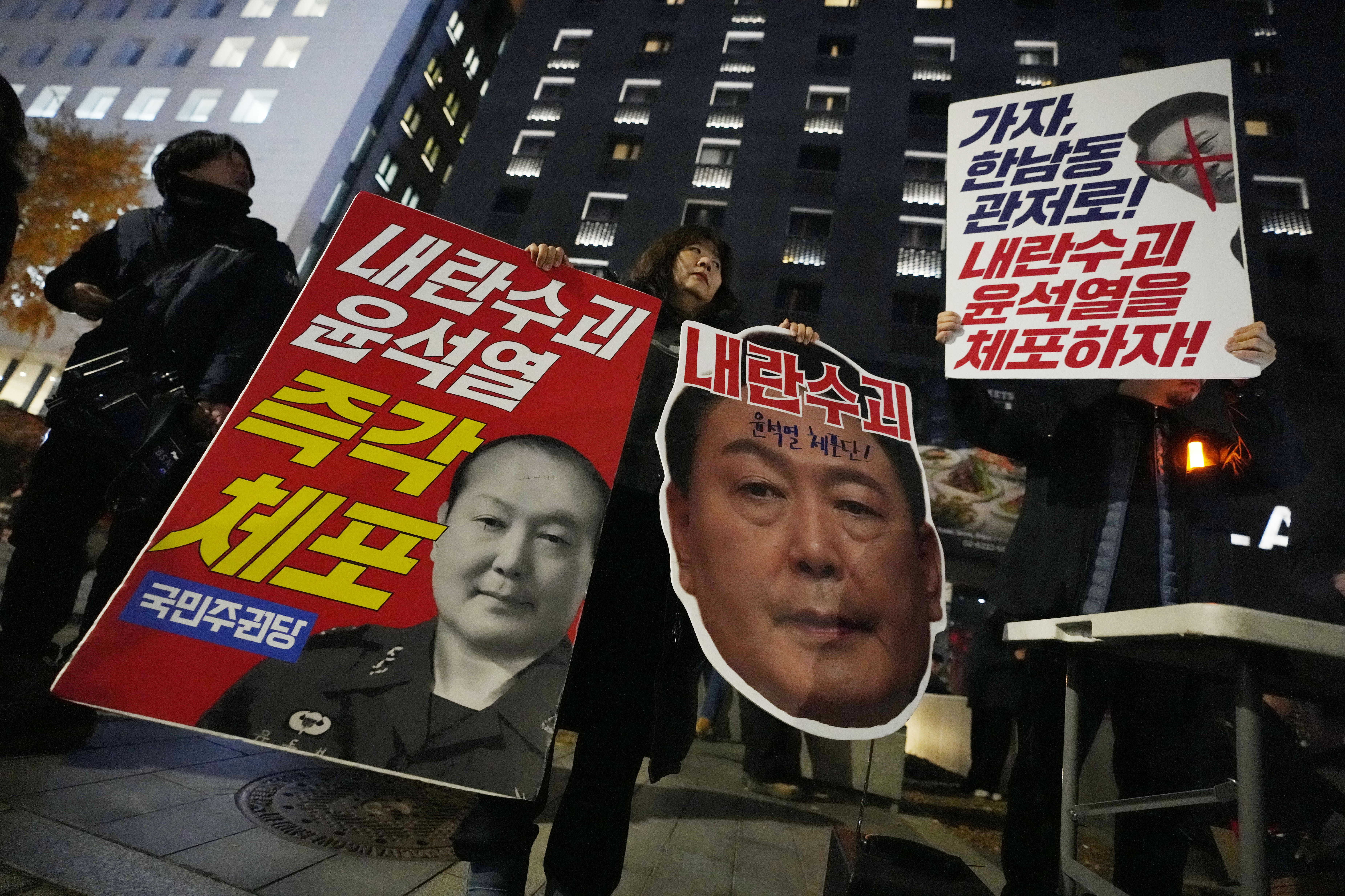 Participants attend a rally to demand South Korean President Yoon Suk Yeol's impeachment outside the National Assembly in Seoul, South Korea, Monday, Dec. 9, 2024. The signs read "Arrest Yoon Suk Yeol." (AP Photo/Ahn Young-joon)